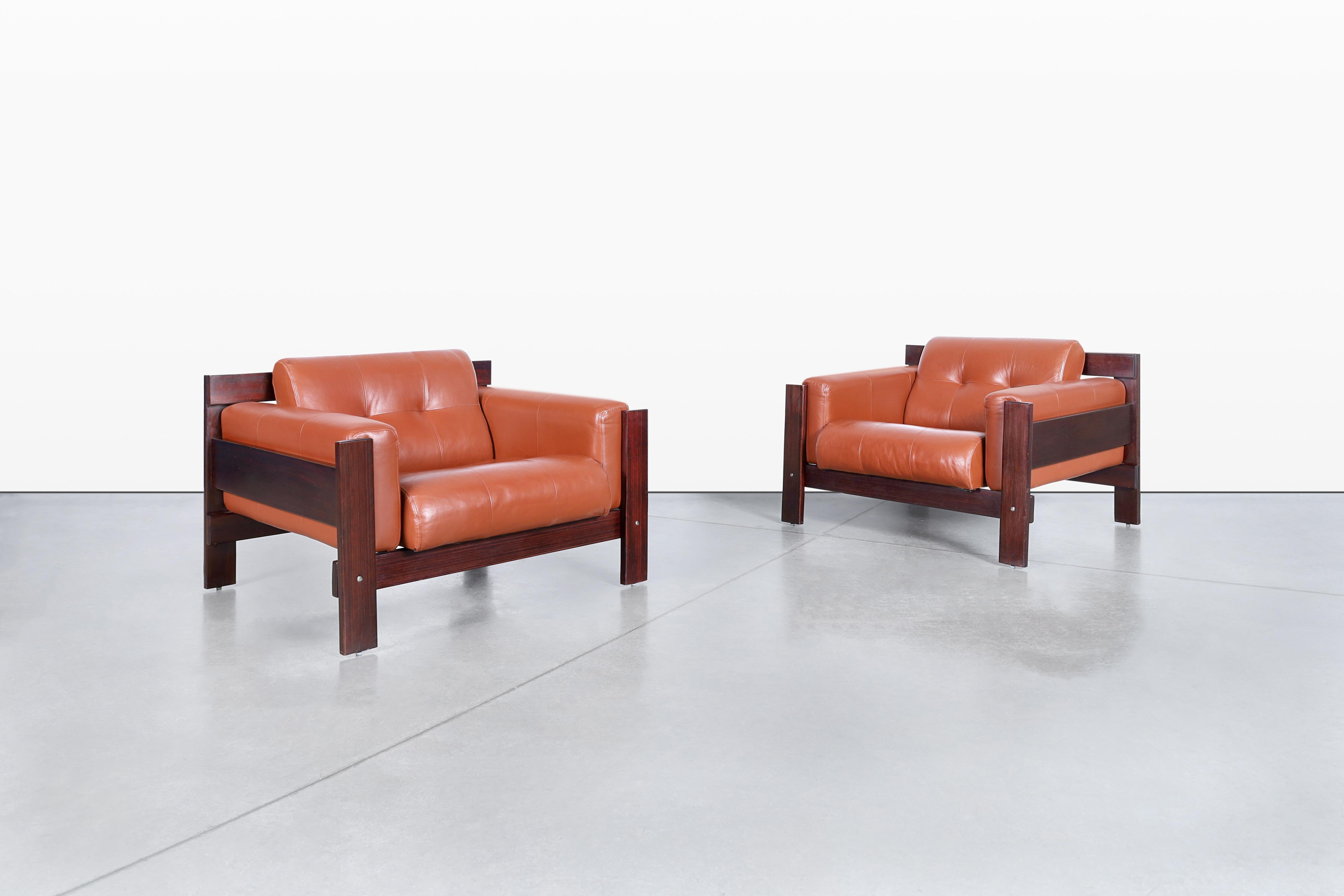 Discover the elegance of mid-century design with these stunning lounge chairs crafted by the renowned Percival Lafer in Brazil during the 1970s. These oversized chairs are not only a perfect spot for relaxation but also a striking statement piece
