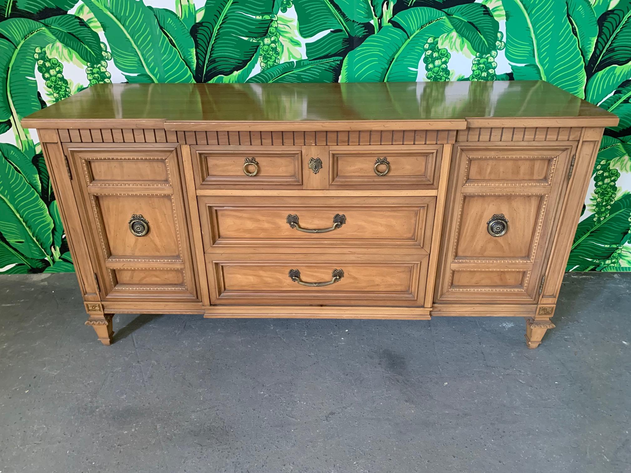 Vintage breakfront server/sideboard features carved detailing and lined stemware drawer. Good vintage condition with minor imperfections consistent with age.