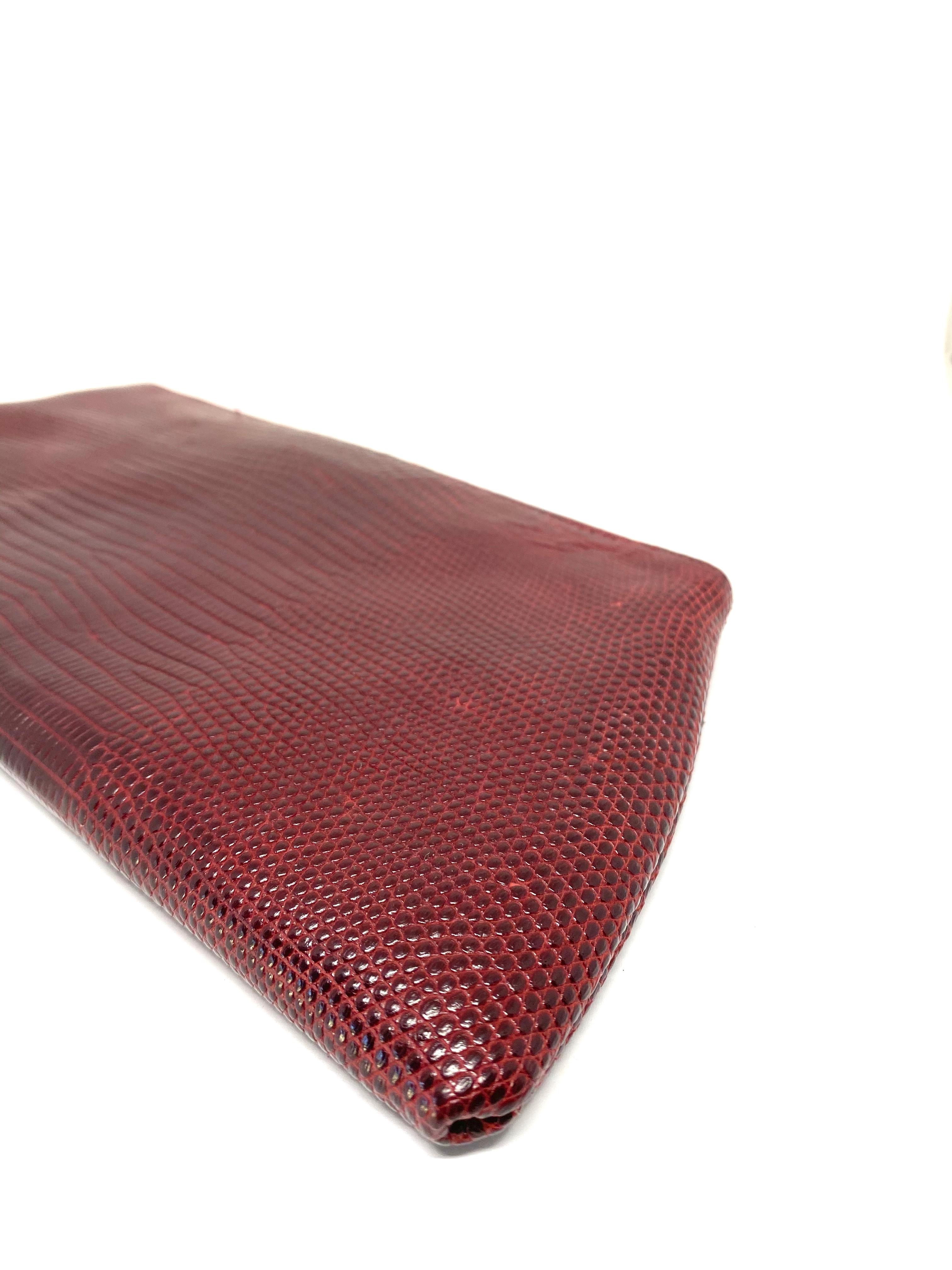 Product details:
Circa 1990
Featuring red burgundy animal/ lizard leather evening clutch with interior pocket with zip closure, double silk lining
Signed
Made in the USA