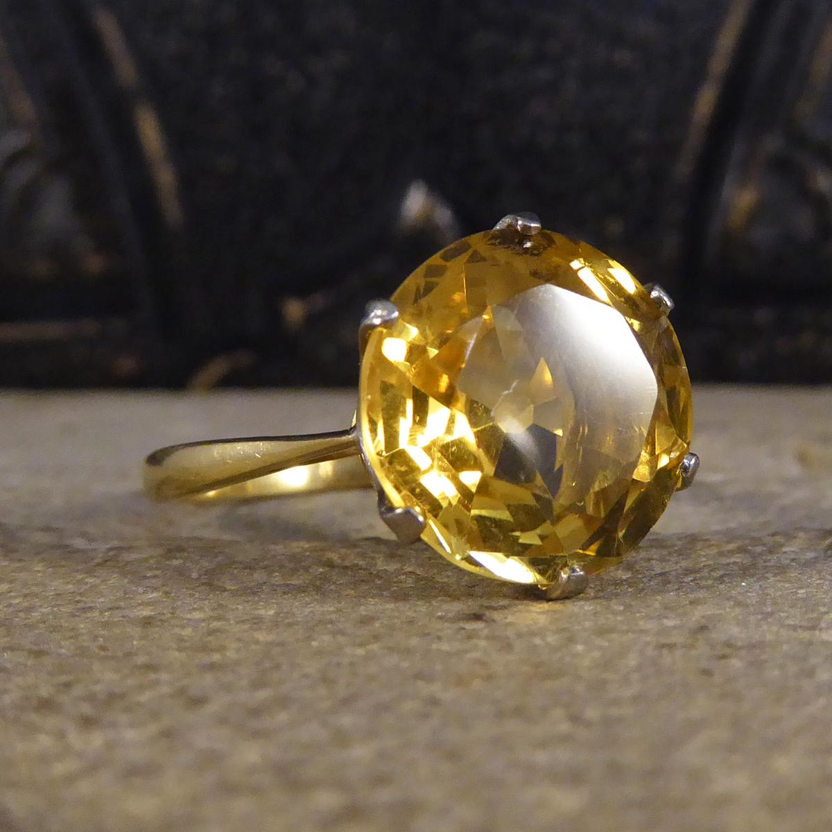 This gorgeous vintage ring features a round cut citrine weighing approximately 5.66ct. It is set in a feature six claw basket setting in 18ct White Gold leading down to a 18ct Yellow Gold plain polished band. A big, bright and colourful piece.

Ring