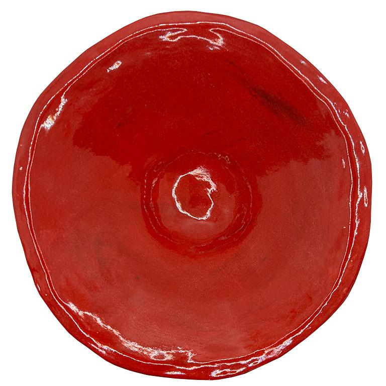 An exquisite handcrafted ceramic pedestal bowl in a vibrant deep cherry red glaze. This piece exudes timeless elegance and artisanal craftsmanship. The wide, gently flared rim and robust pedestal base showcase a harmonious balance of form and