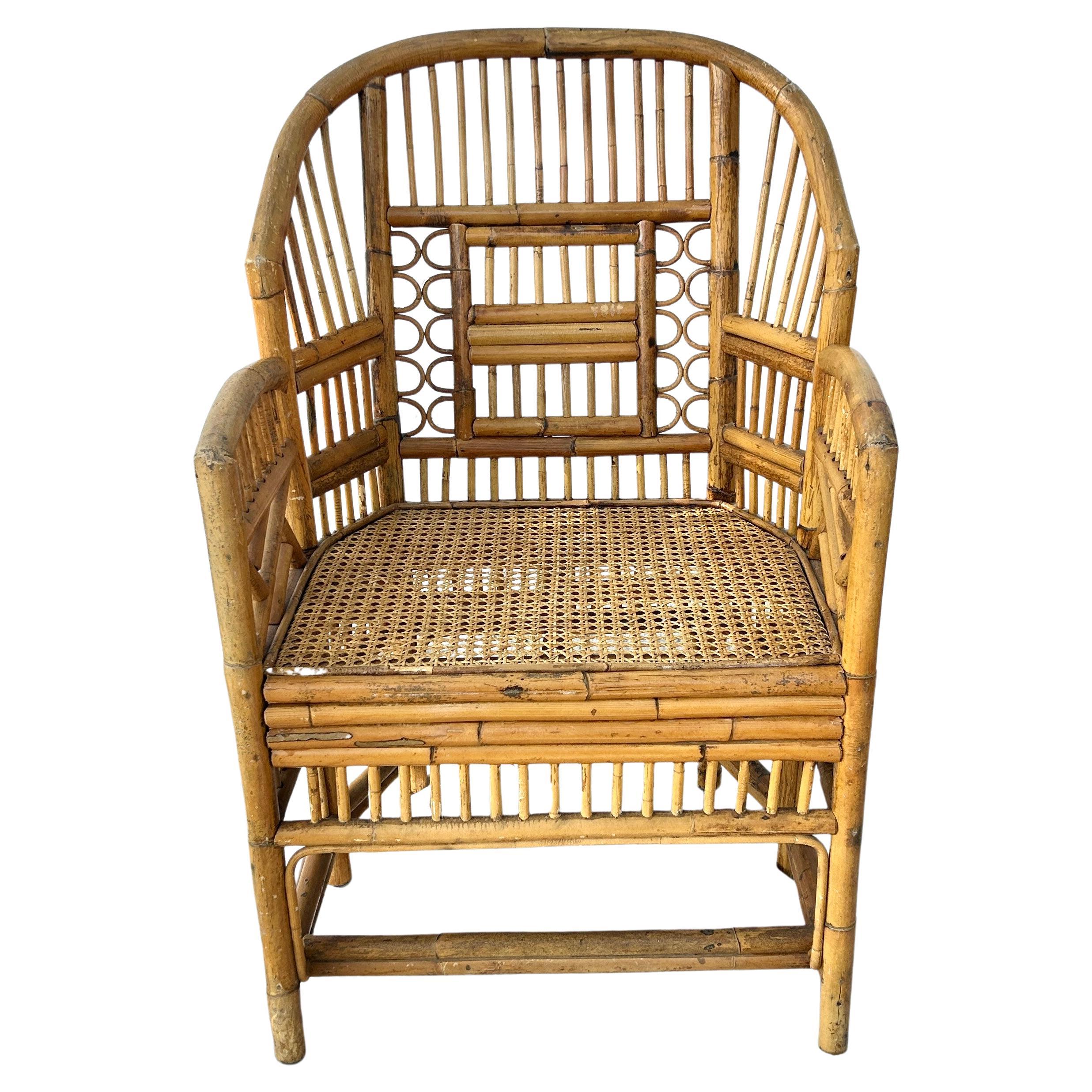 Vintage Brighton Pavilion Chinoiserie rattan burnt bamboo armchair on six legs. Handcrafted chair has woven cane seat and bamboo frame. Very sturdy with intact rattan and bamboo throughout. Perfect addition to decor in any indoor or outdoor room.