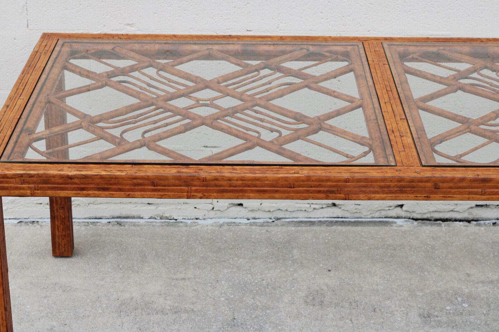Gorgeous Brighton Pavilion style tortoiseshell burnt bamboo rattan dining table, circa 1970s. Expertly crafted and beautifully finished with burning techniques, this rectangular 78