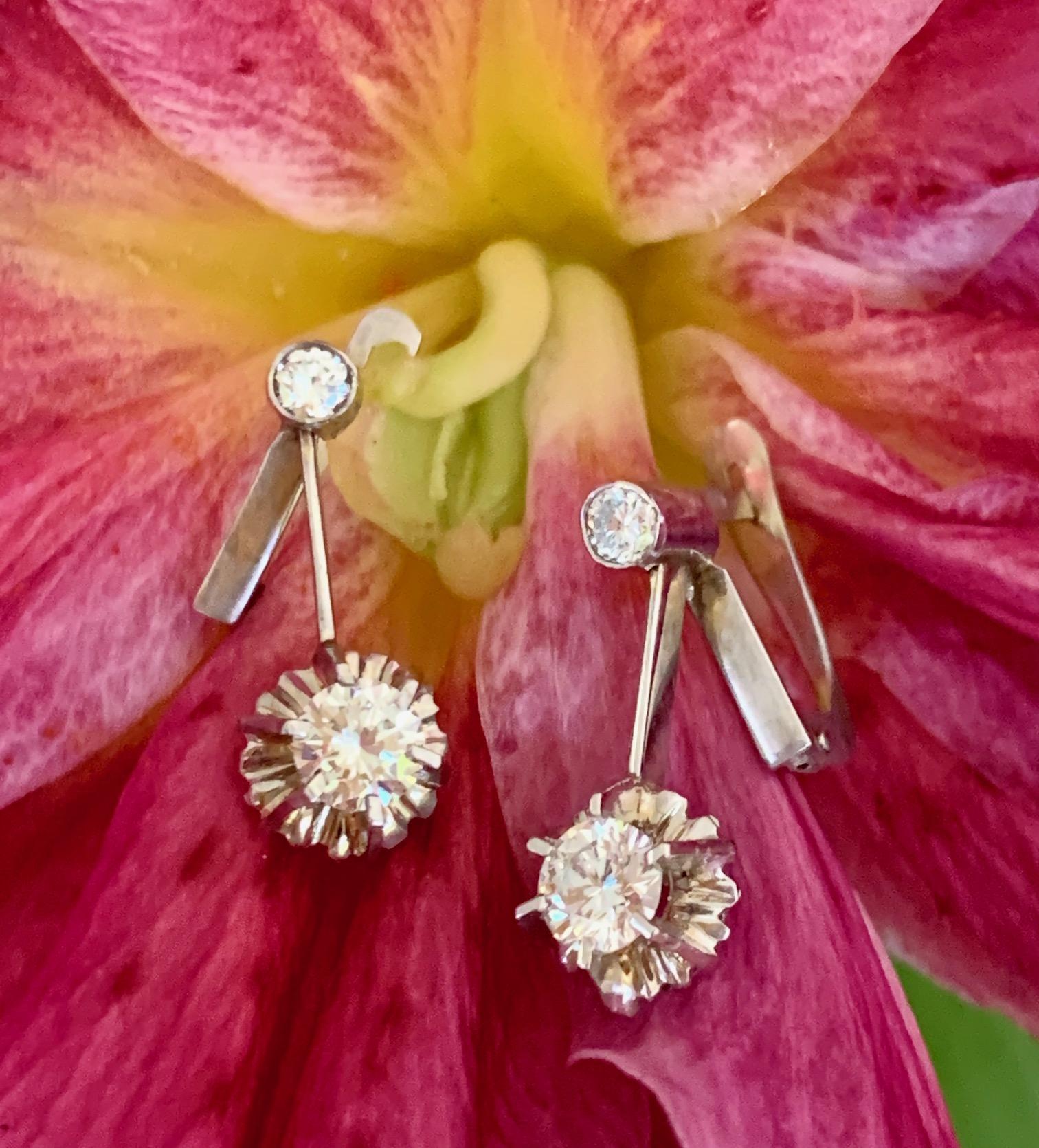 These earrings are vintage brilliant cut Diamonds set in 14k white Gold. 

Features:
2 (1 per earring) Brilliant Cut Diamonds = approximately .60 ctw Clarity: SI/H

Pendant Size: 3/4