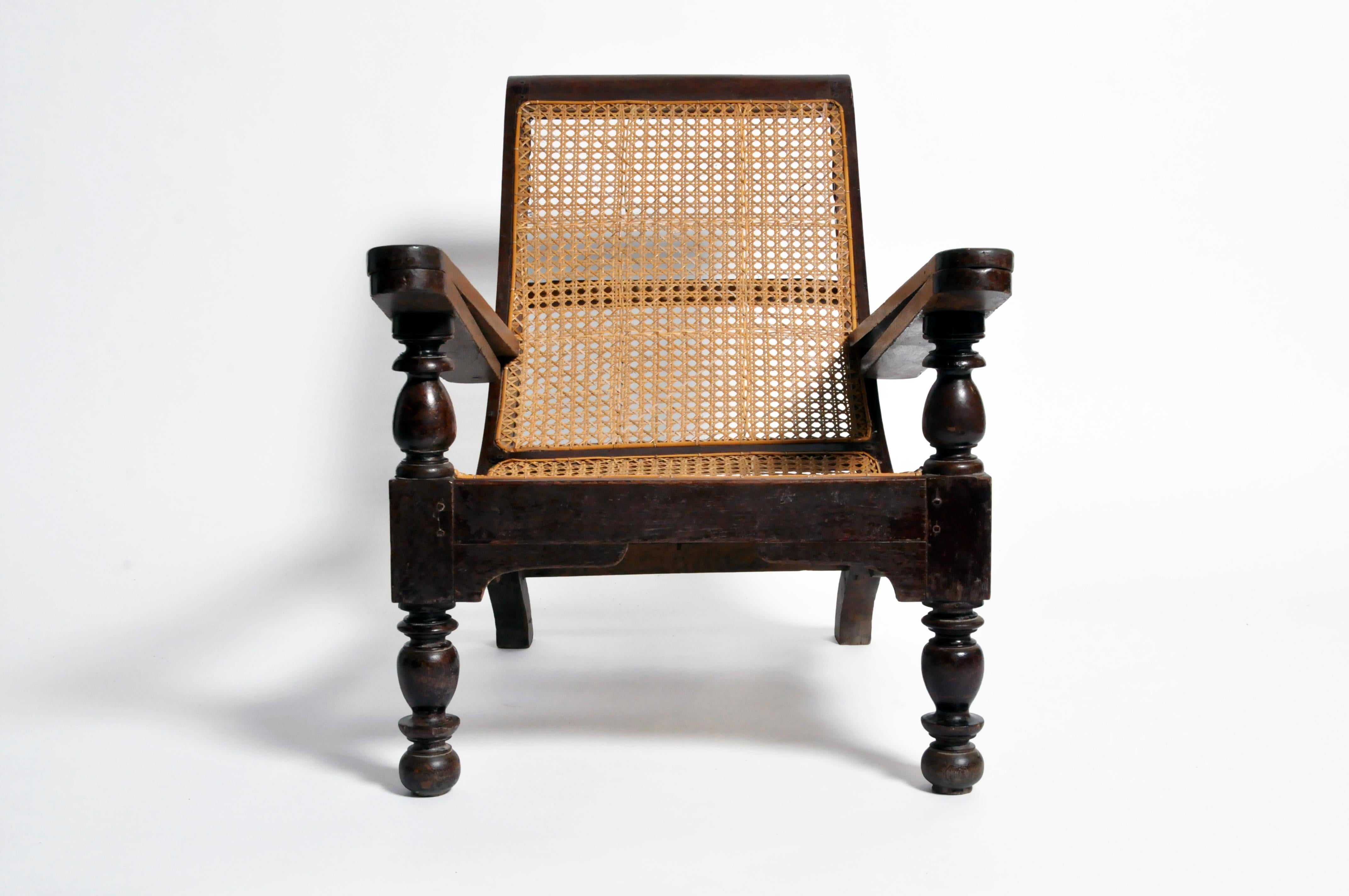 This Indian “plantation chair” was actually an officer’s chair.  British military officers reclined on chairs like these before removing their boots after riding.  The armrest features a swing-out foot rest that elevated one’s legs to alleviate