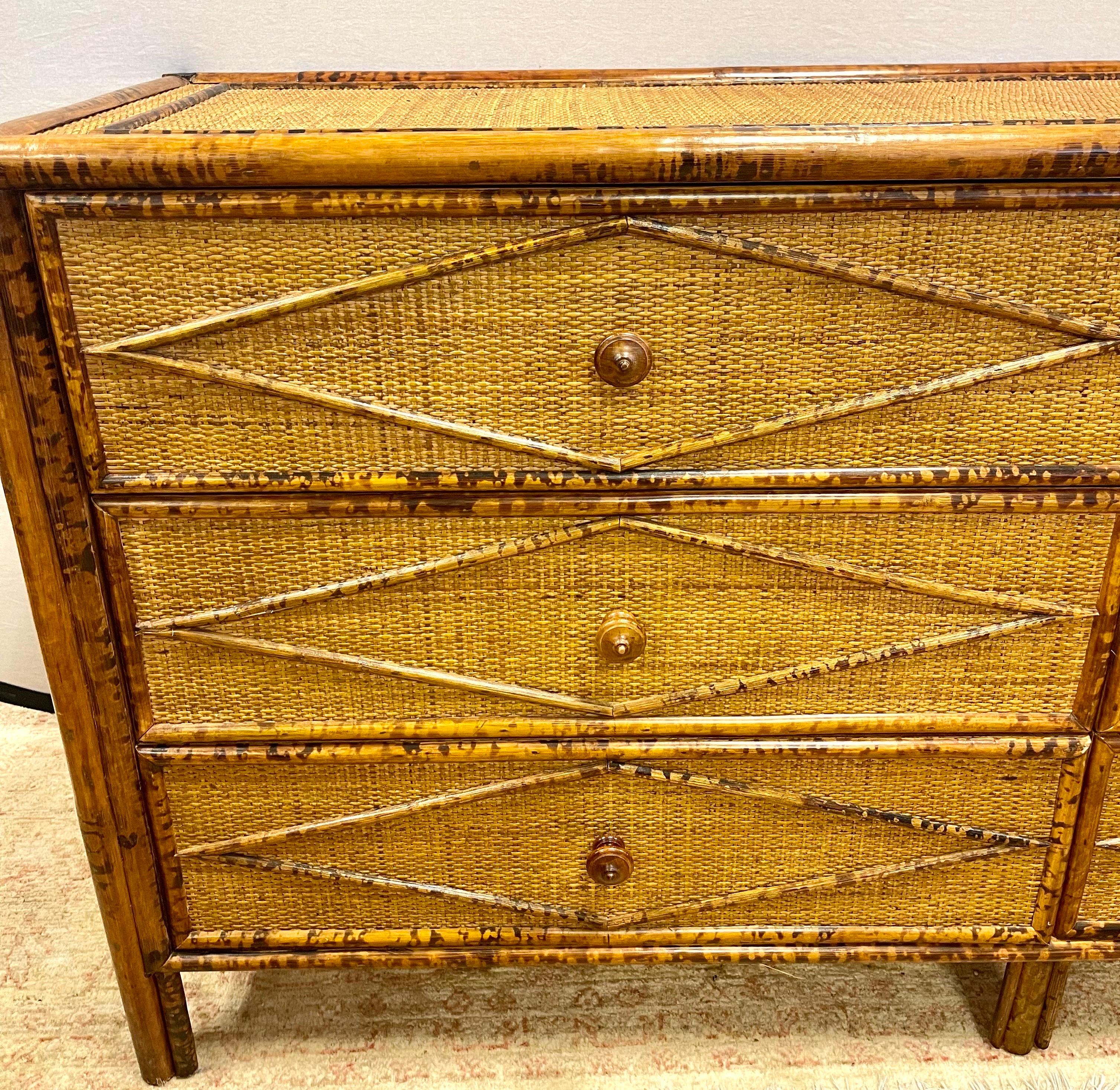 Vintage British colonial style dresser in bamboo and rattan. Top, sides and eight spacious drawers are covered in rattan and have a burnt bamboo frame for a tortoiseshell finish. Wonderful bamboo diamond pattern throughout.