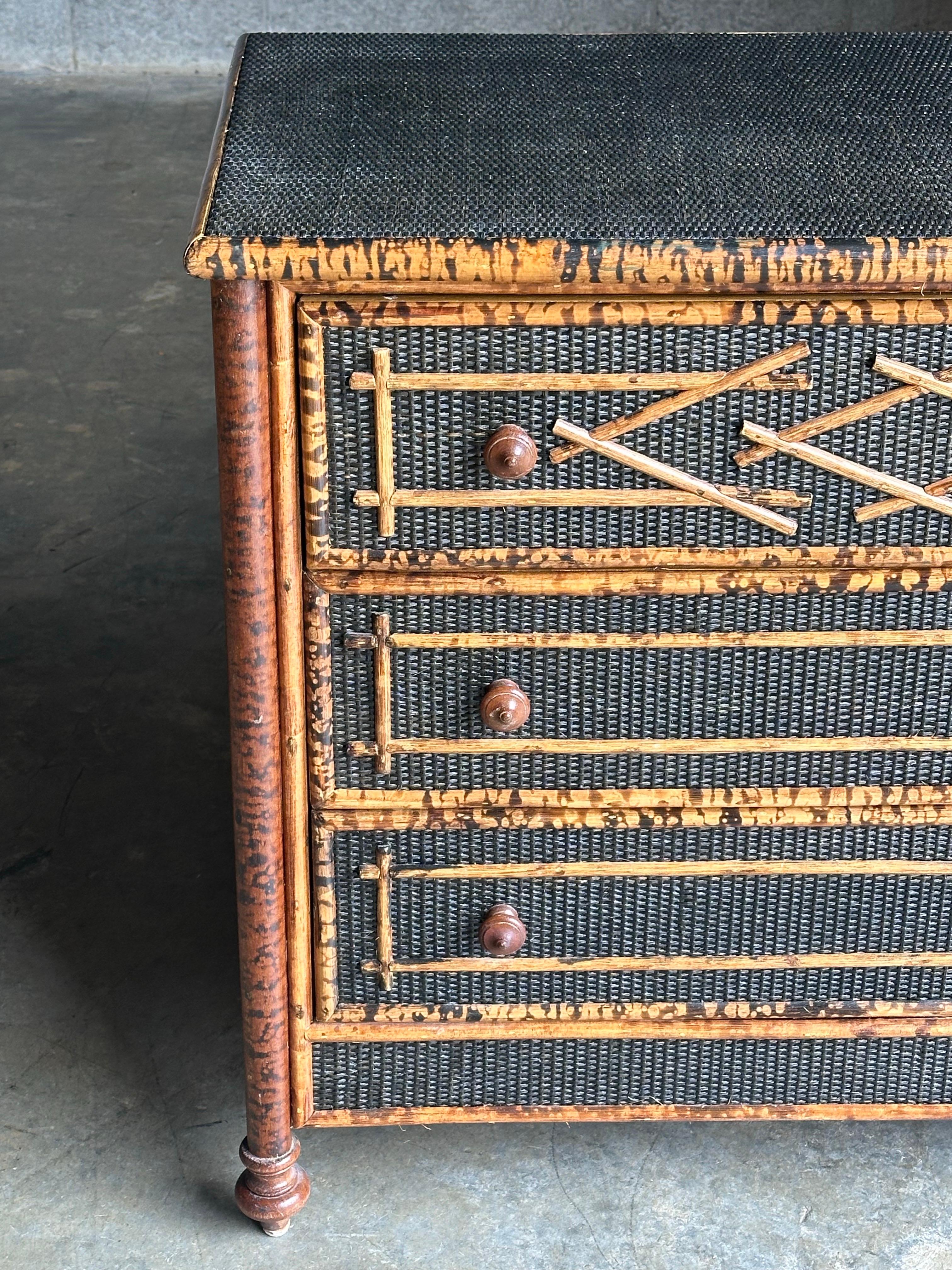 Vintage British colonial style dresser in bamboo and rattan. Three spacious drawers clad in rattan with a bamboo skeleton. Wonderful geometric pattern throughout. Would work in a variety of interiors.

 Design is attributed to Ralph Lauren for