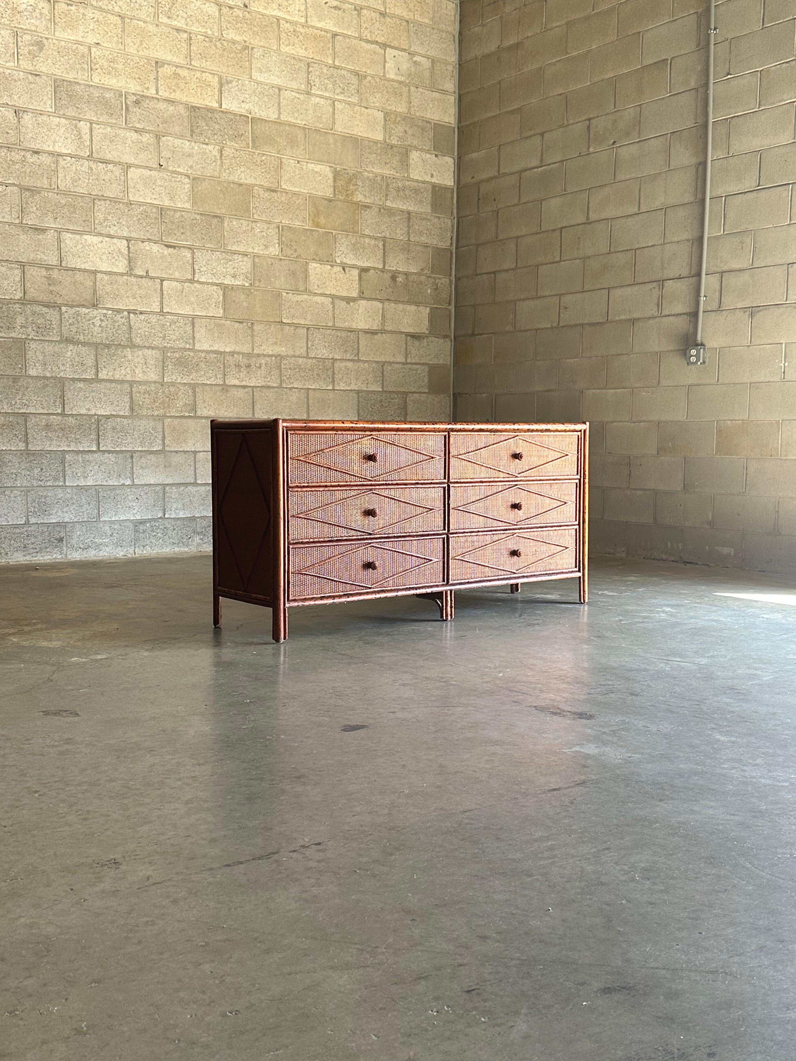 Vintage British colonial style dresser in bamboo and rattan. Six spacious drawers clad in rattan with a bamboo skeleton. Wonderful diamond pattern throughout. Would work in a variety of interiors. Design is attributed to Ralph Lauren, would also