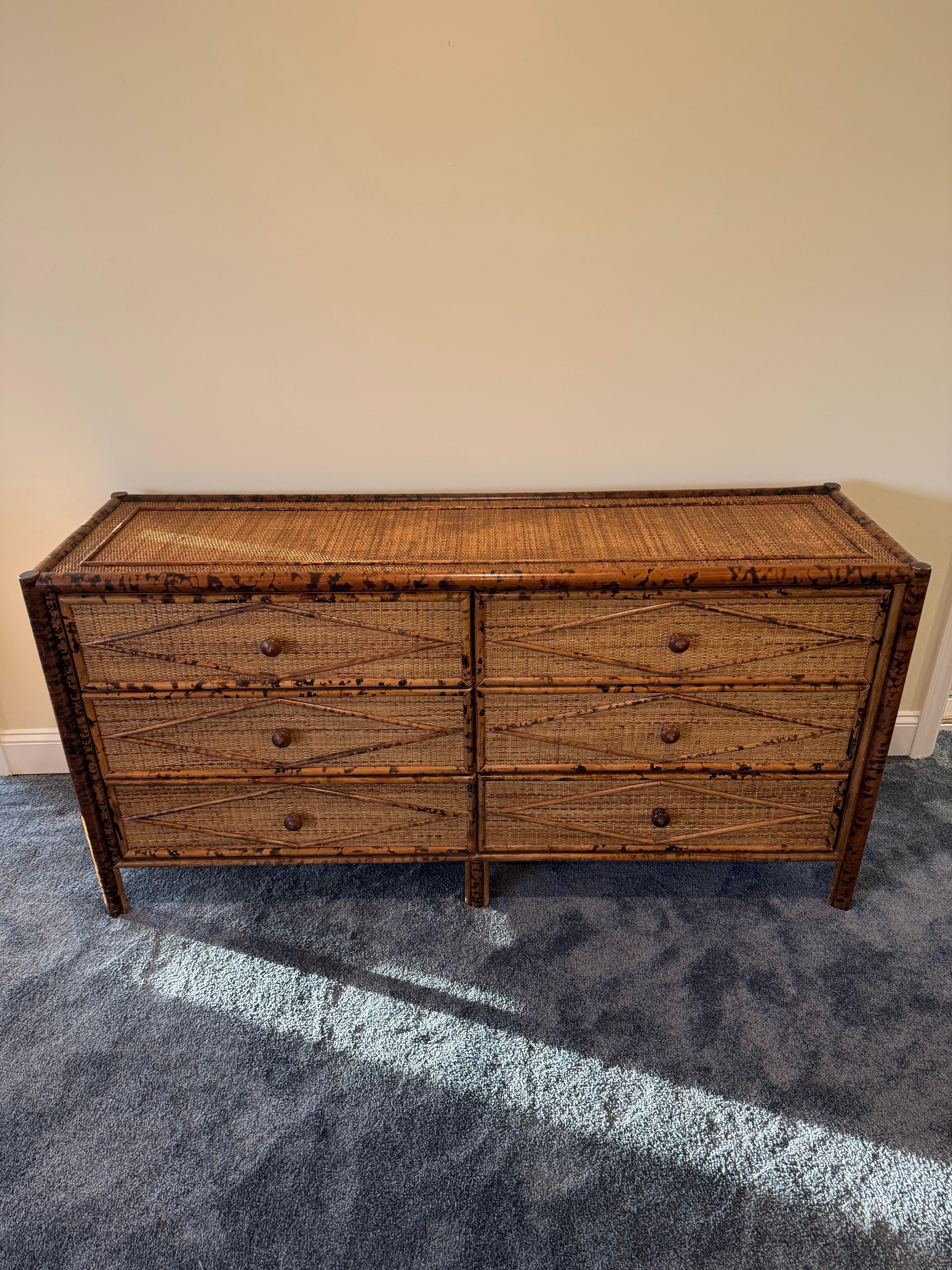 Comò in stile British Colonial vintage in bambù e rattan. Sei cassetti spaziosi rivestiti in rattan con uno scheletro in bambù. Meraviglioso motivo a diamante su tutta la superficie. Si adatta a diversi tipi di interni. Il design è attribuito a