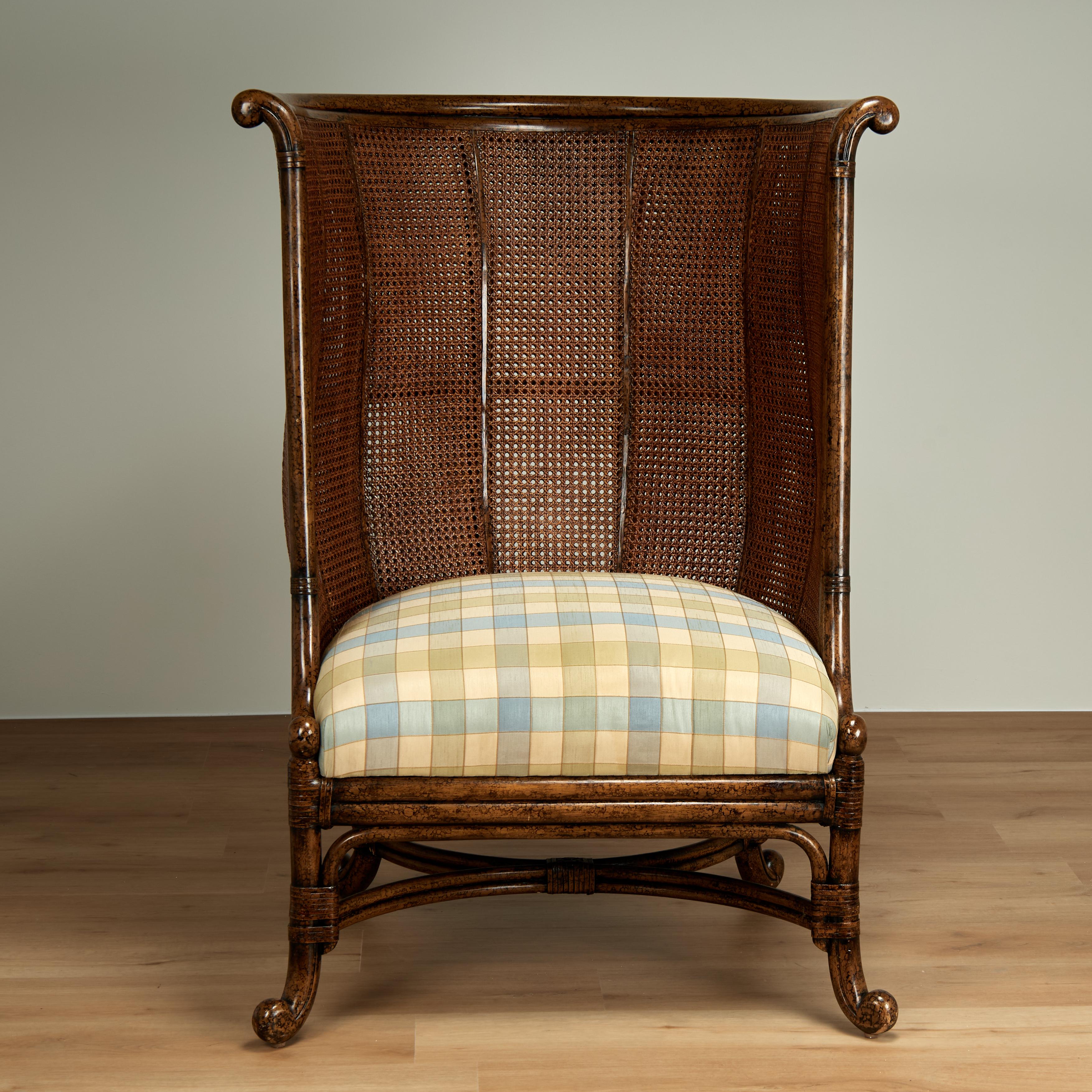 Impressive mid century British colonial style high back chair handcrafted with a faux tortoise wood frame, double caned sides and back, upholstered seat and chic rolled feet. Signed Maitland Smith on the back.
