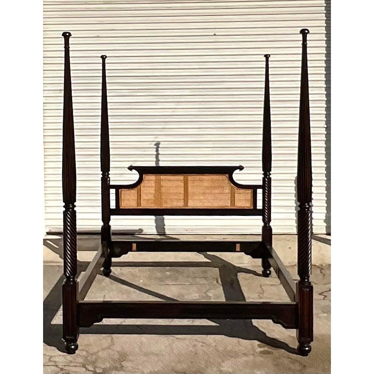 Spectacular vintage British Khaki four poster bed. Beautiful twisted posts with a chic cane panel headboard. The coveted queen size. Acquired from a Palm Beach estate.