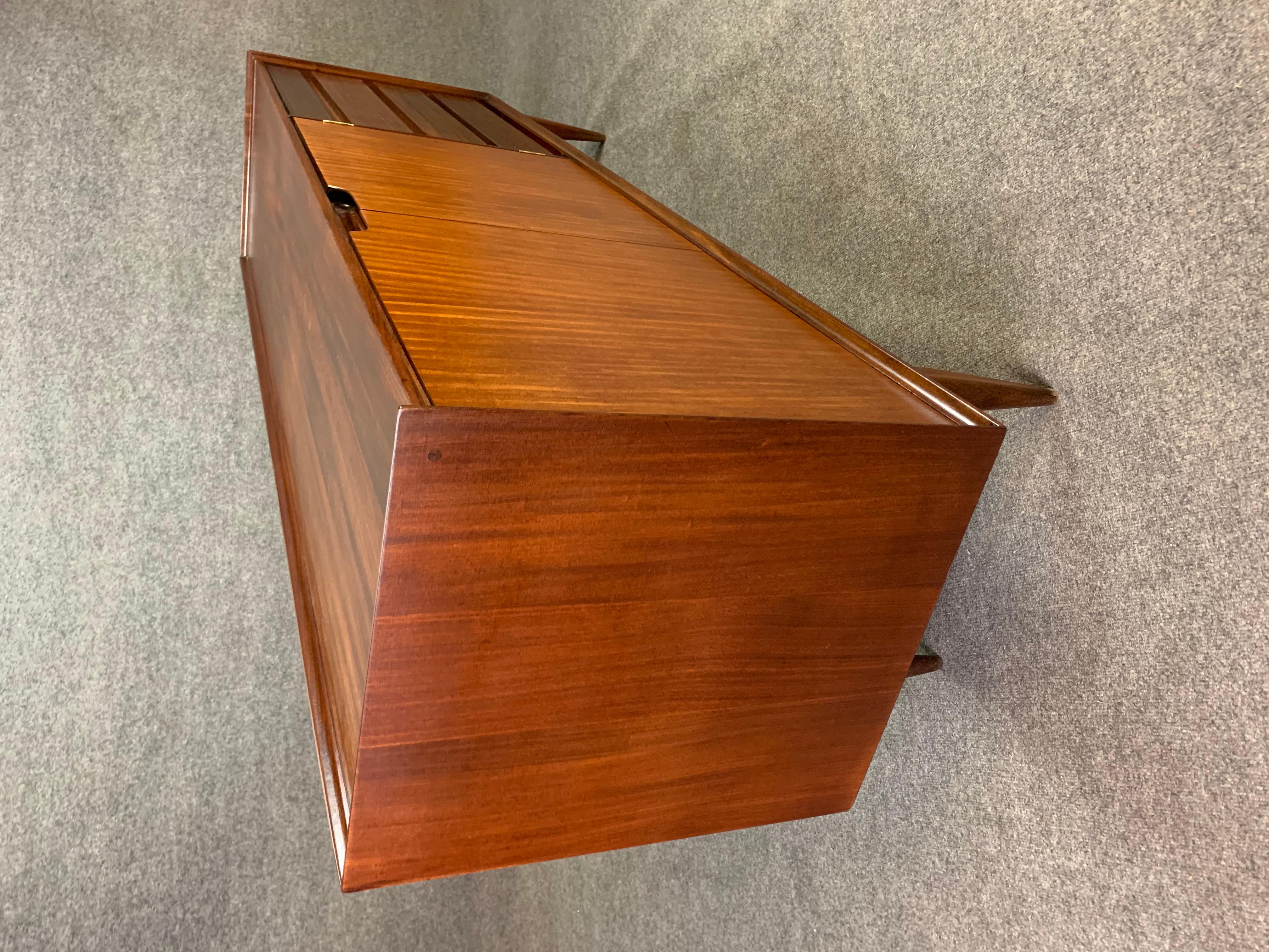 Here is a rare and beautiful british Mid-Century Modern sideboard in afromasia teak designed by Richard Hornby and manufactured by Fyne Lady of Banbury in England in the 1960s.
This special case piece, recently imported from Europe to California