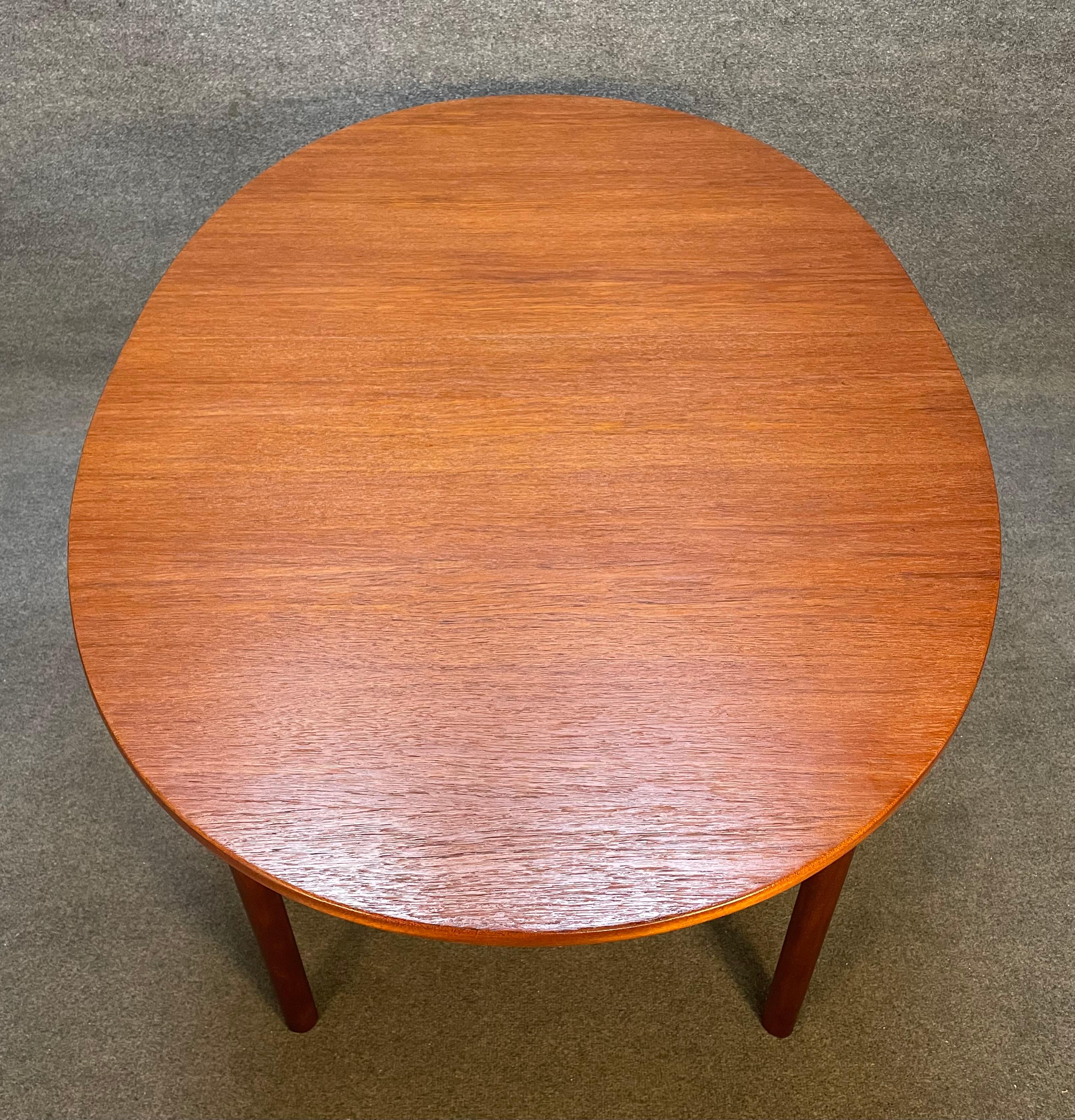 Here is a beautiful British mid century modern teak dining table manufactured in Scotland by McIntosh in the 1960's.
This exquisite dining table, recently imported from Europe to California before its refinishing, features an oval shape, a vibrant