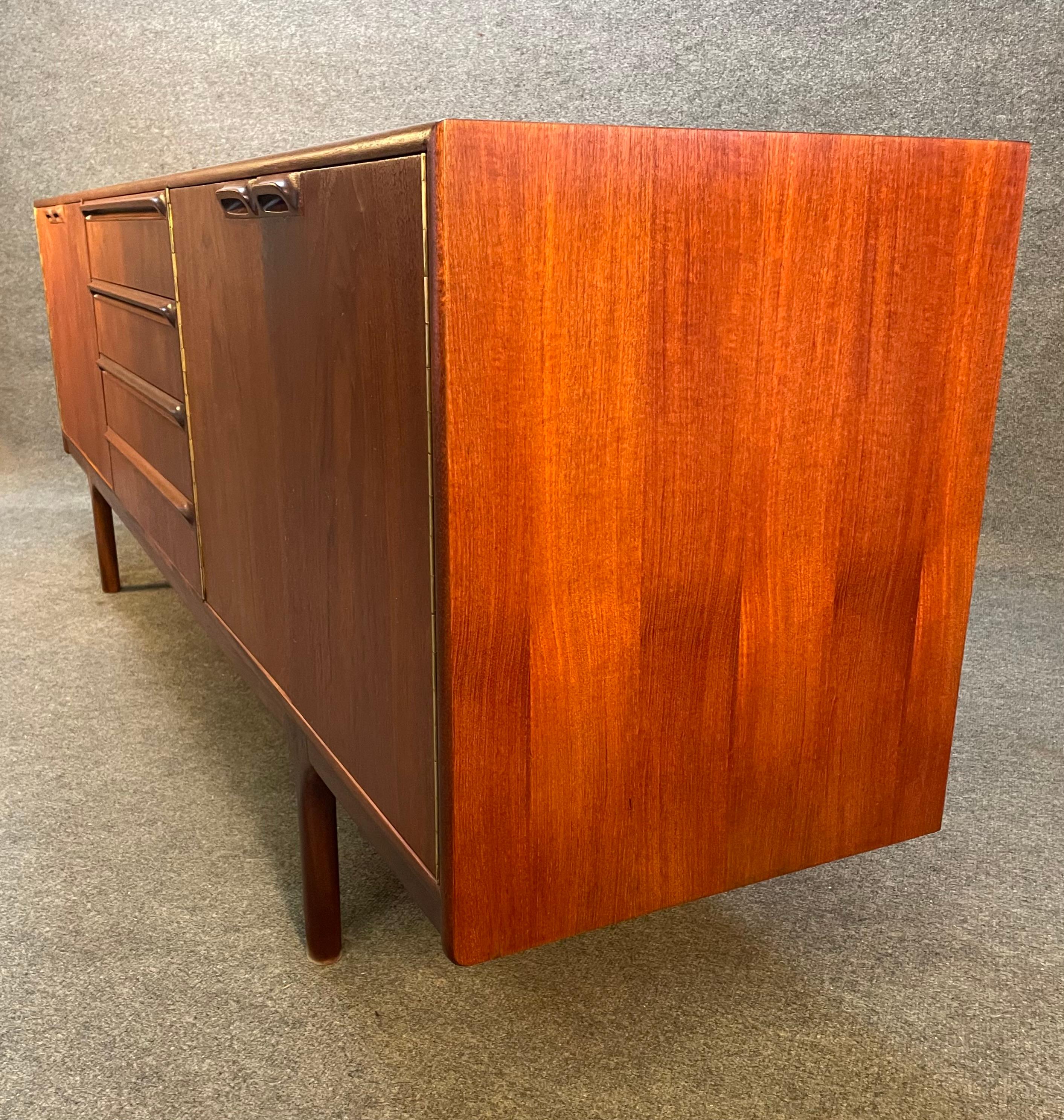 Here is a beautiful British Mid-Century Modern credenza model 