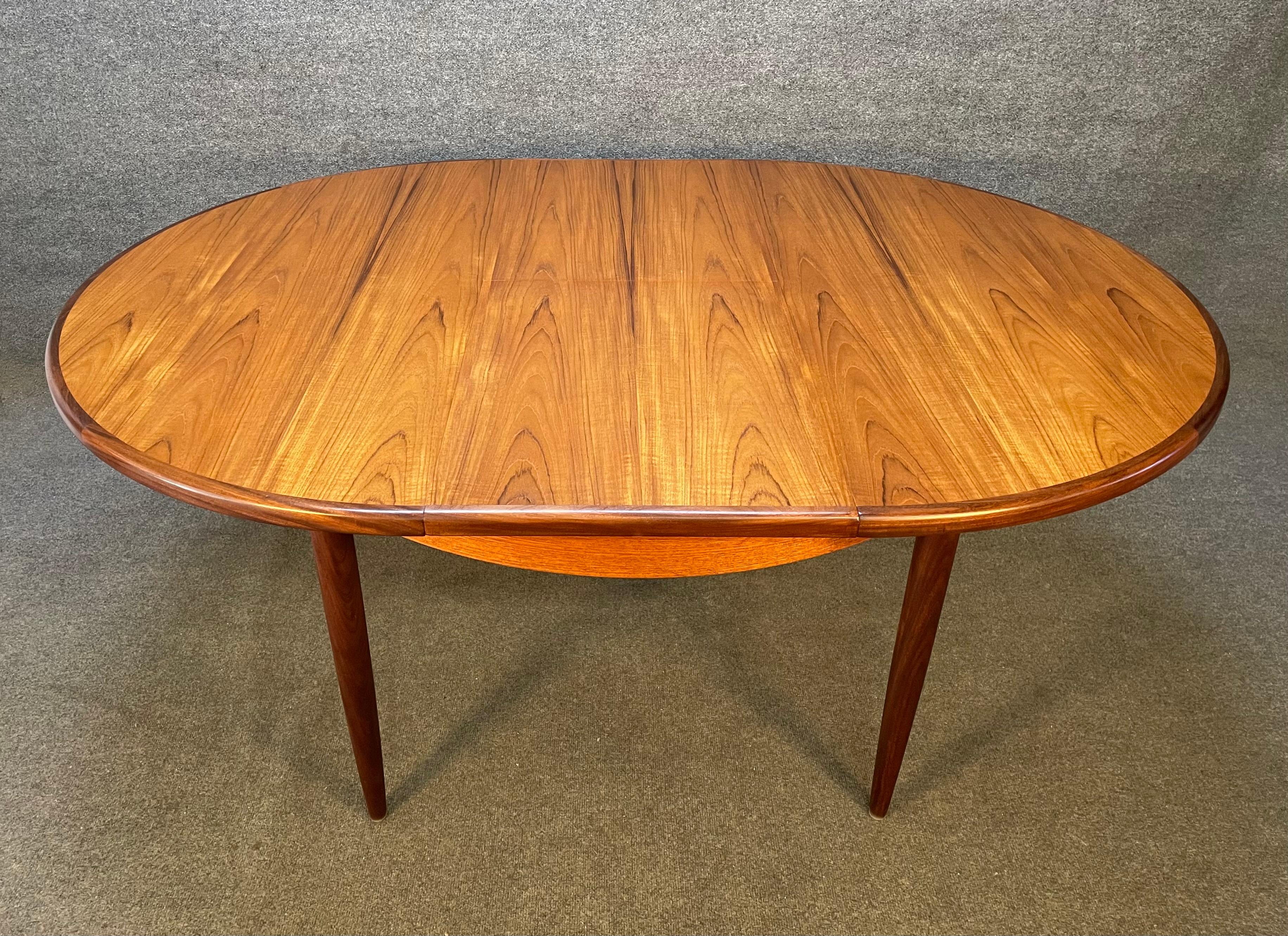 Here is a beautiful British Mid-Century Modern round dining table in teak designed by Victor Wilkins for the 