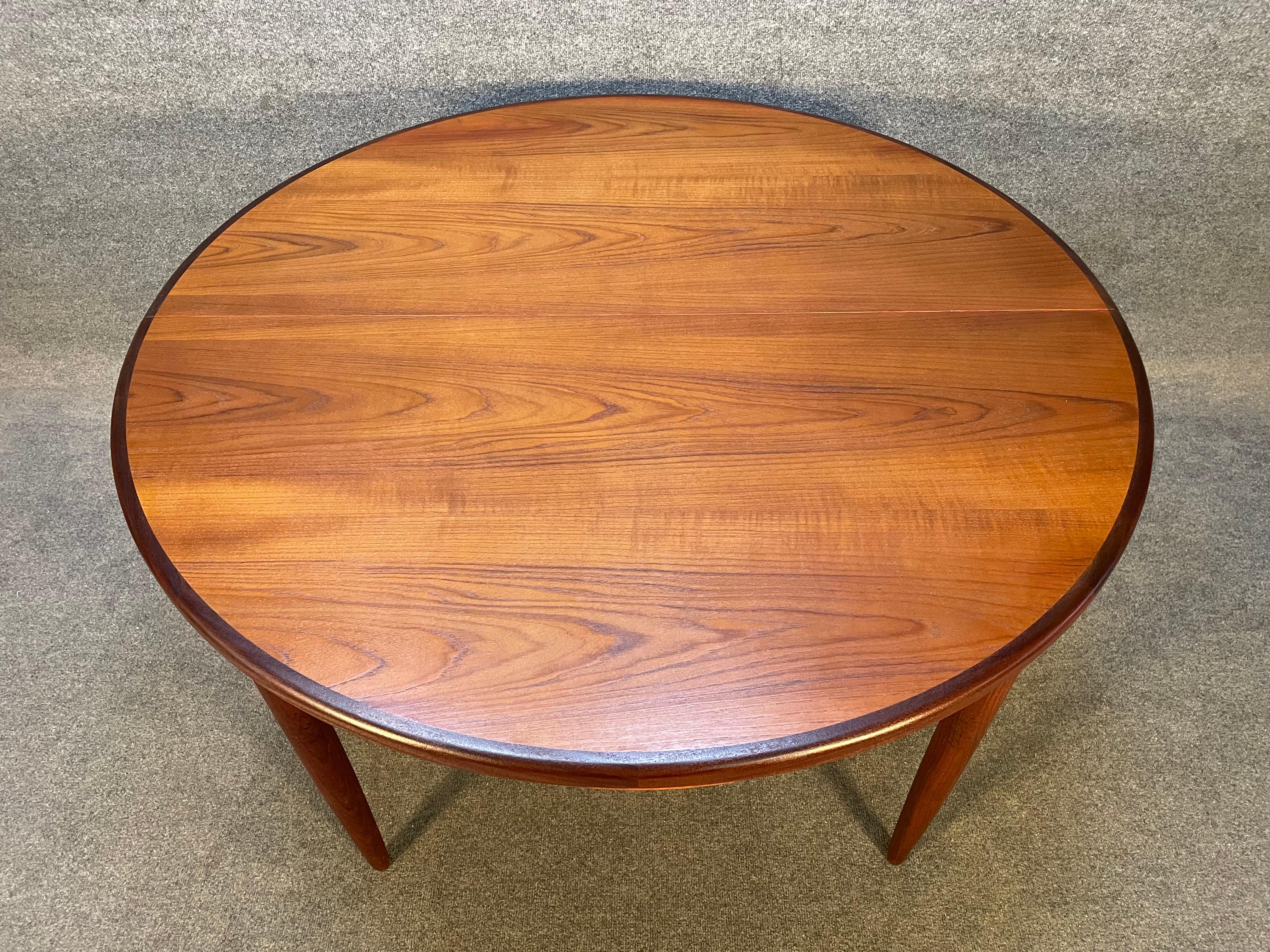Here is a beautiful British Mid-Century Modern round dining table in teak designed by Victor Wilkins for the 