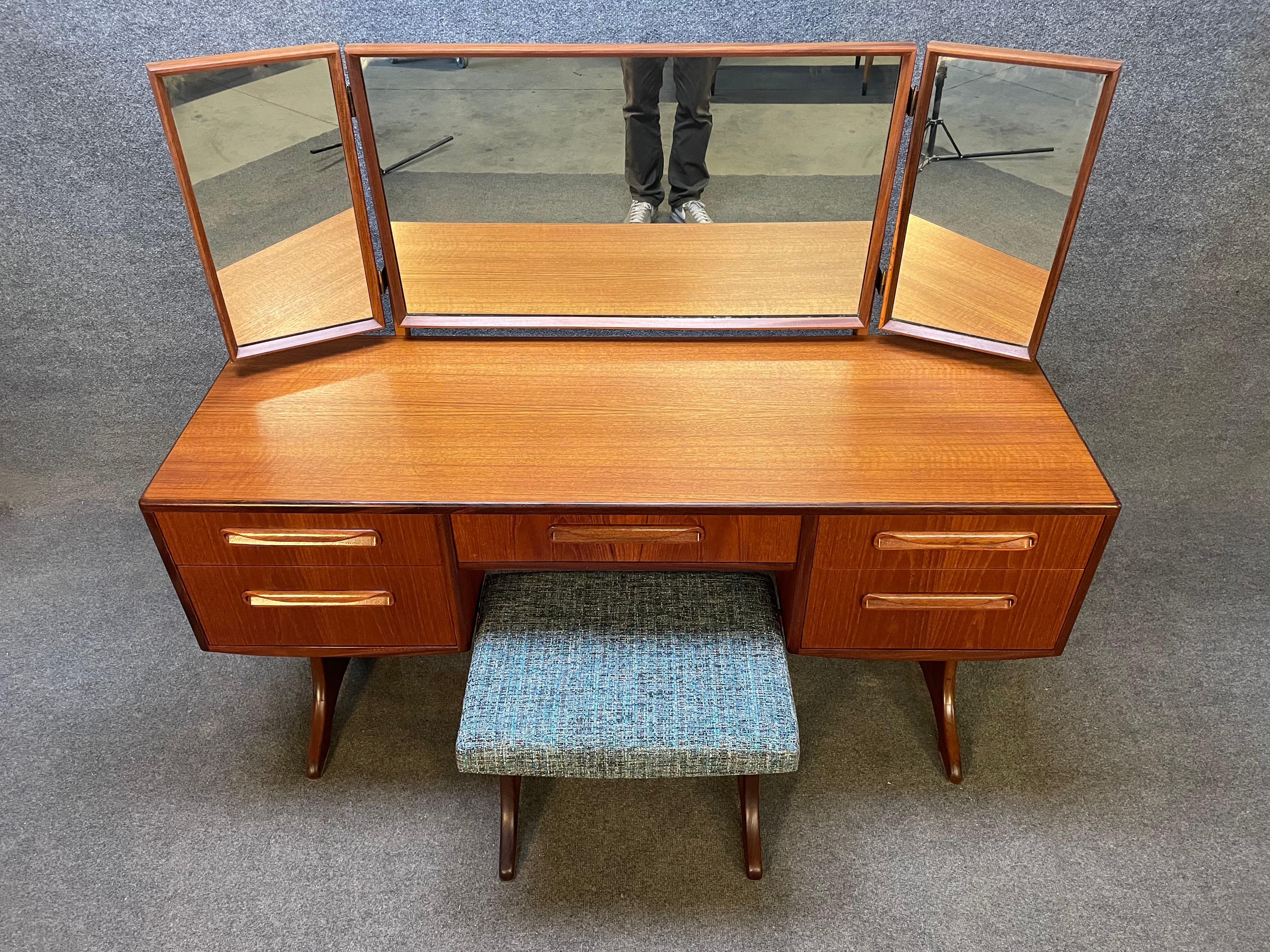 Here is a beautiful British MCM teak dressing table with its mirror and ottoman from the 