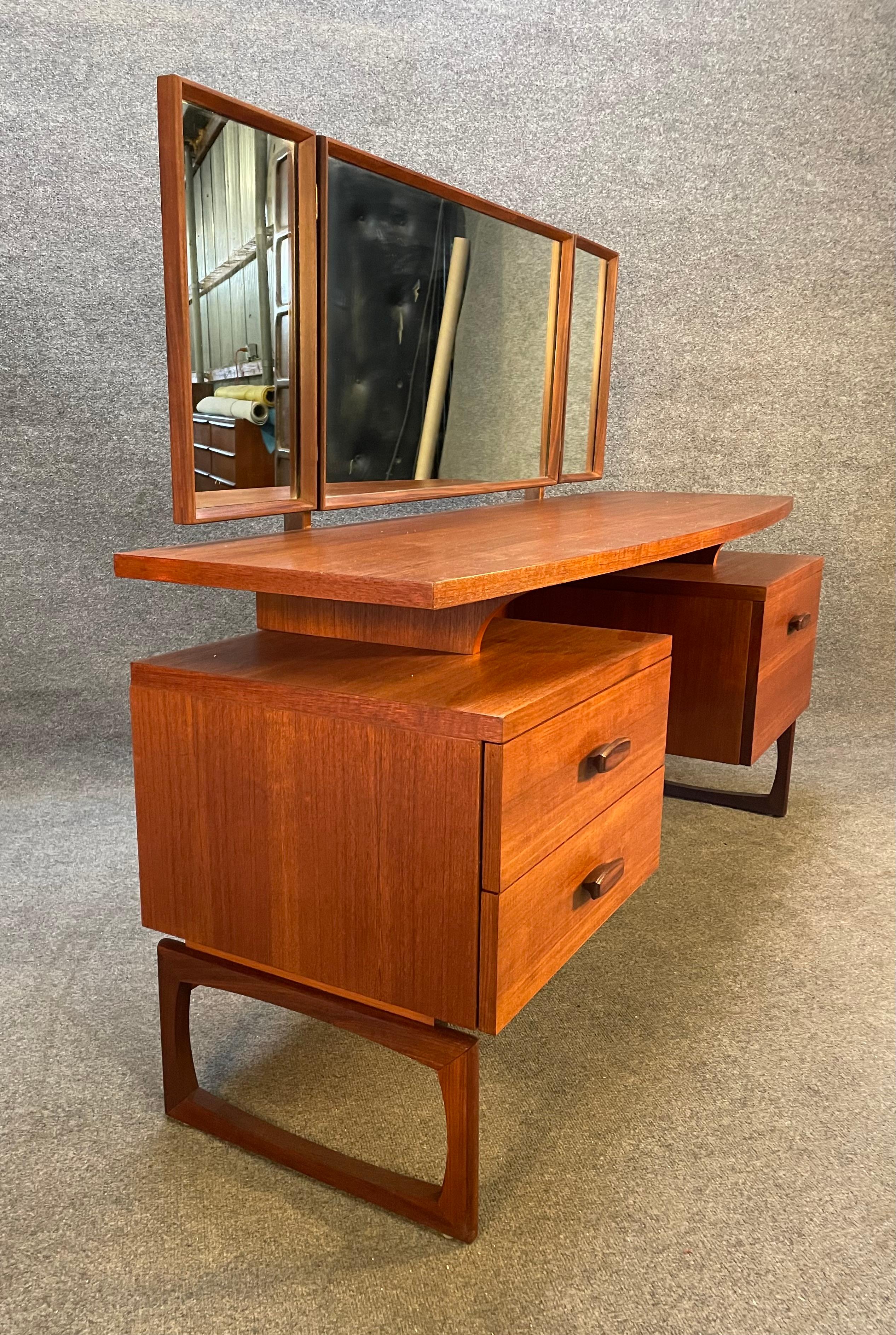 Here is beautiful Mid-Century Modern teak vanity - dressing table in teak wood designed by R. Bennett and manufactured by G Plan in England in the 1960's.
This exquisite piece, recently imported from the UK to California before its refinishing,