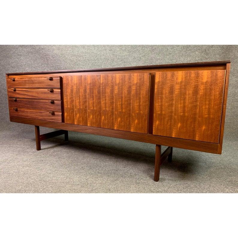 Here is an exquisite 1960s teak sideboard designed by Robert Heritage and manufactured by Archie Shine Furniture in England.
This 
