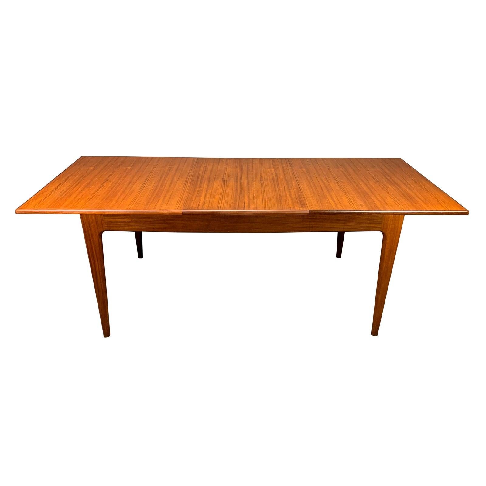 Here is an exclusive British Mid-Century Modern dining table designed by John Herbert and manufactured by A. Younger Ltd in Scotland in the 1960s.
This beautiful table, recently imported from UK to California before its restoration, features a