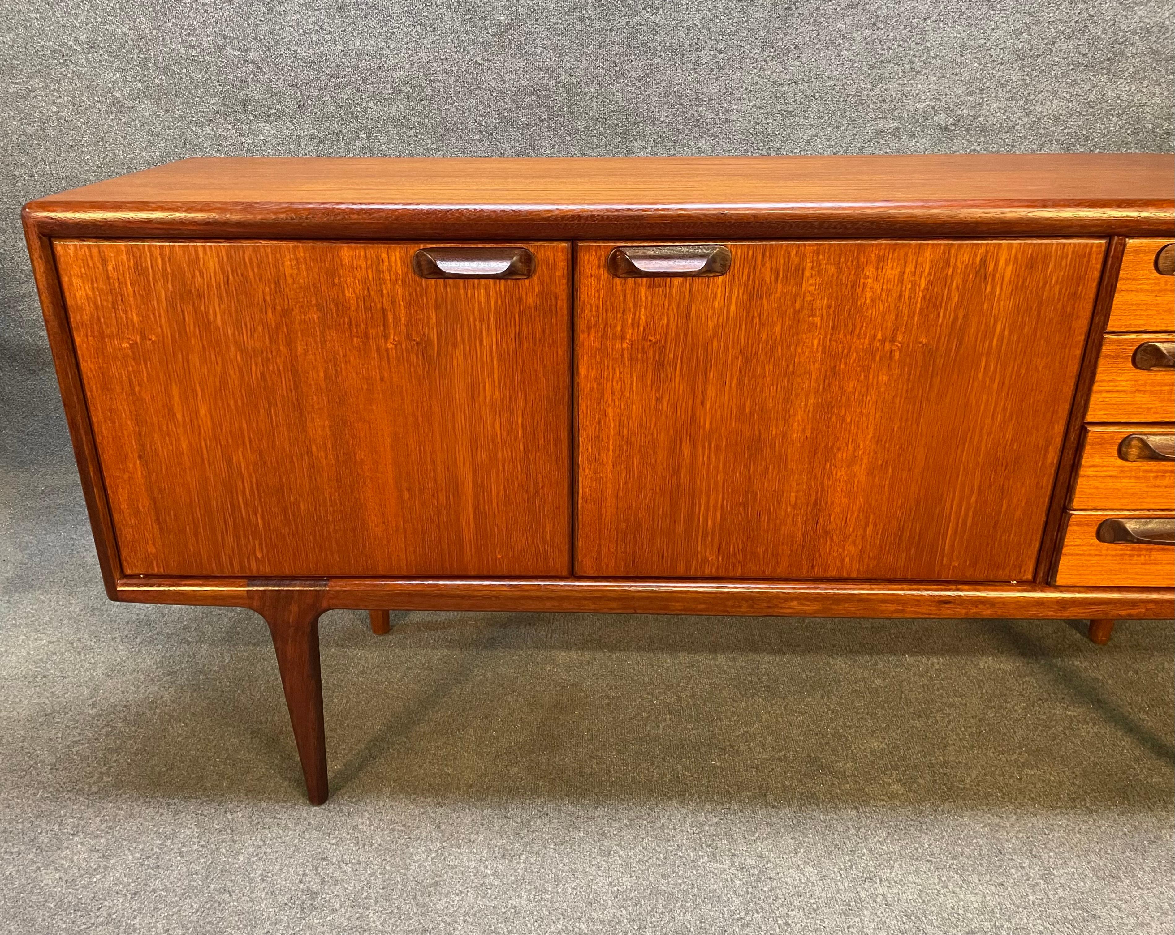 Here is a beautiful MCM modern compact sideboard in teak part of the 