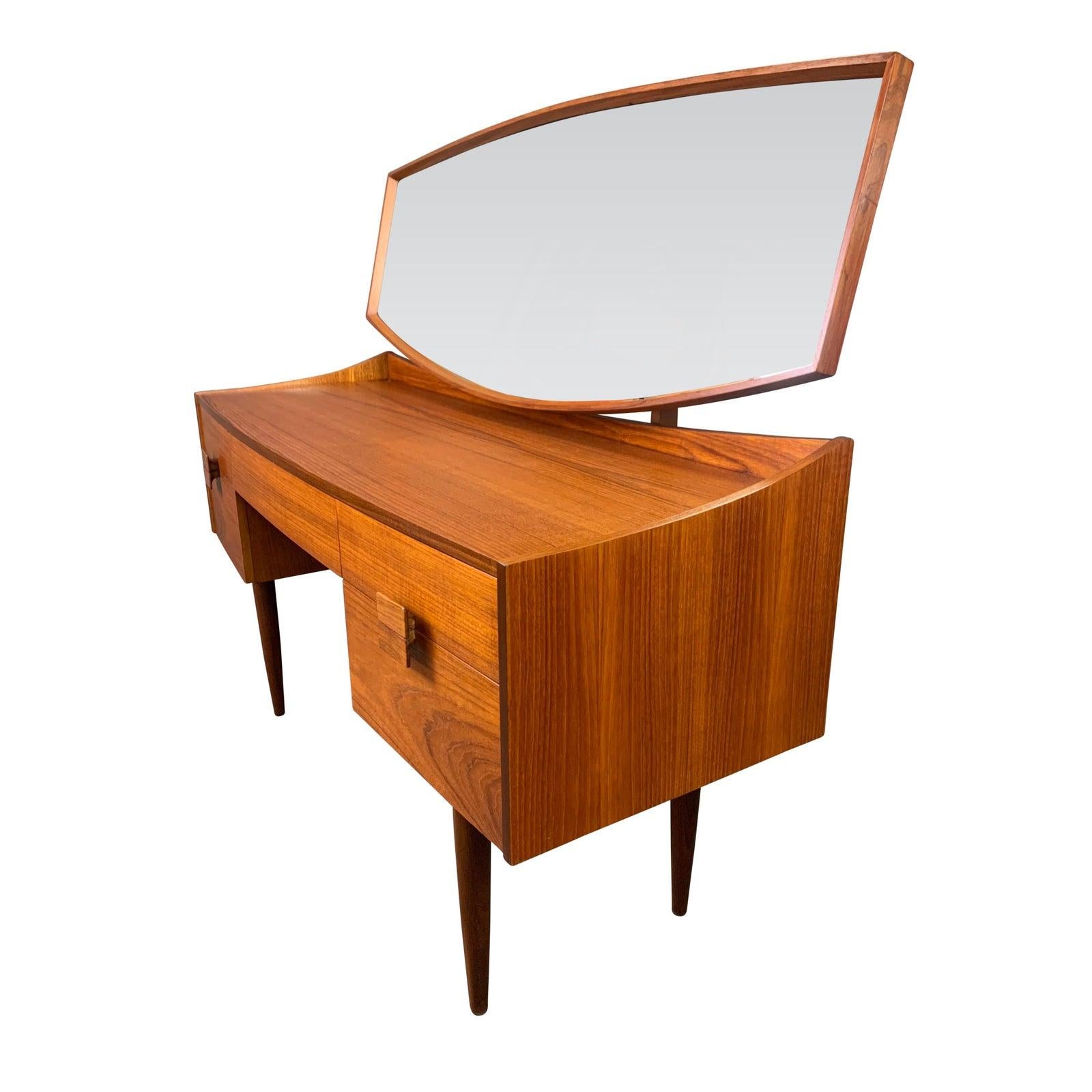 Here is a rare British MCM teak dressing table and its mirror designed by master Ib Kofod Larsen part of the sought after 