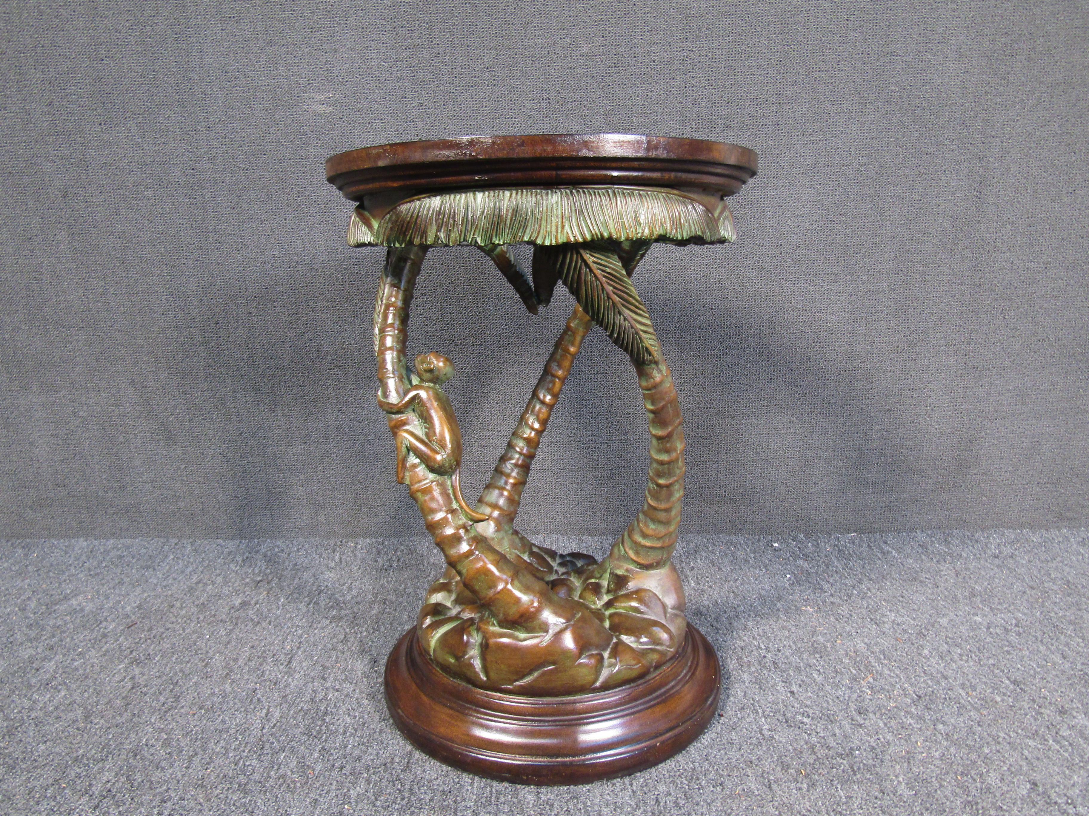 With intricate details including a monkey and palm trees, this vintage end table features a sculptural base of wood and bronze with a glass top. Please confirm item location with seller (NY/NJ).