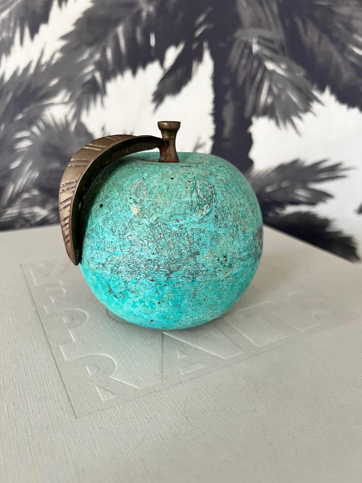 1970's French figurative sculpture and paperweight of a bronze apple with an oxidized green patinated finish.
The sculpture features a stylized stem and leaf in bronzed metal with incised carved details. Makes the perfect desk accessory or