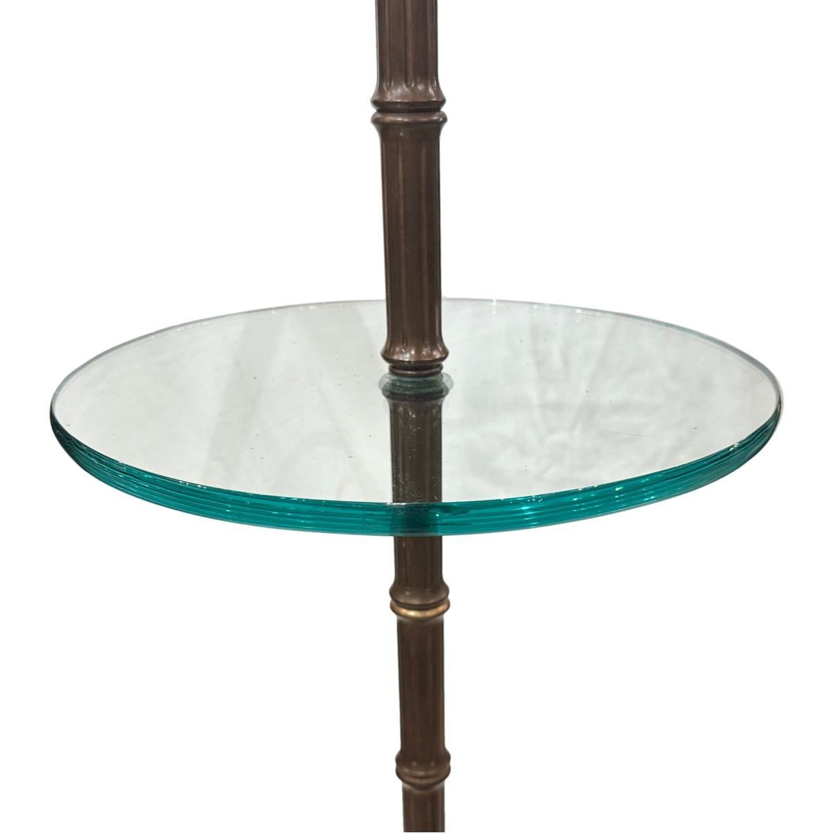 A circa 1940's French gilt metal floor lamp with glass table.

Measurements:
Height: 59