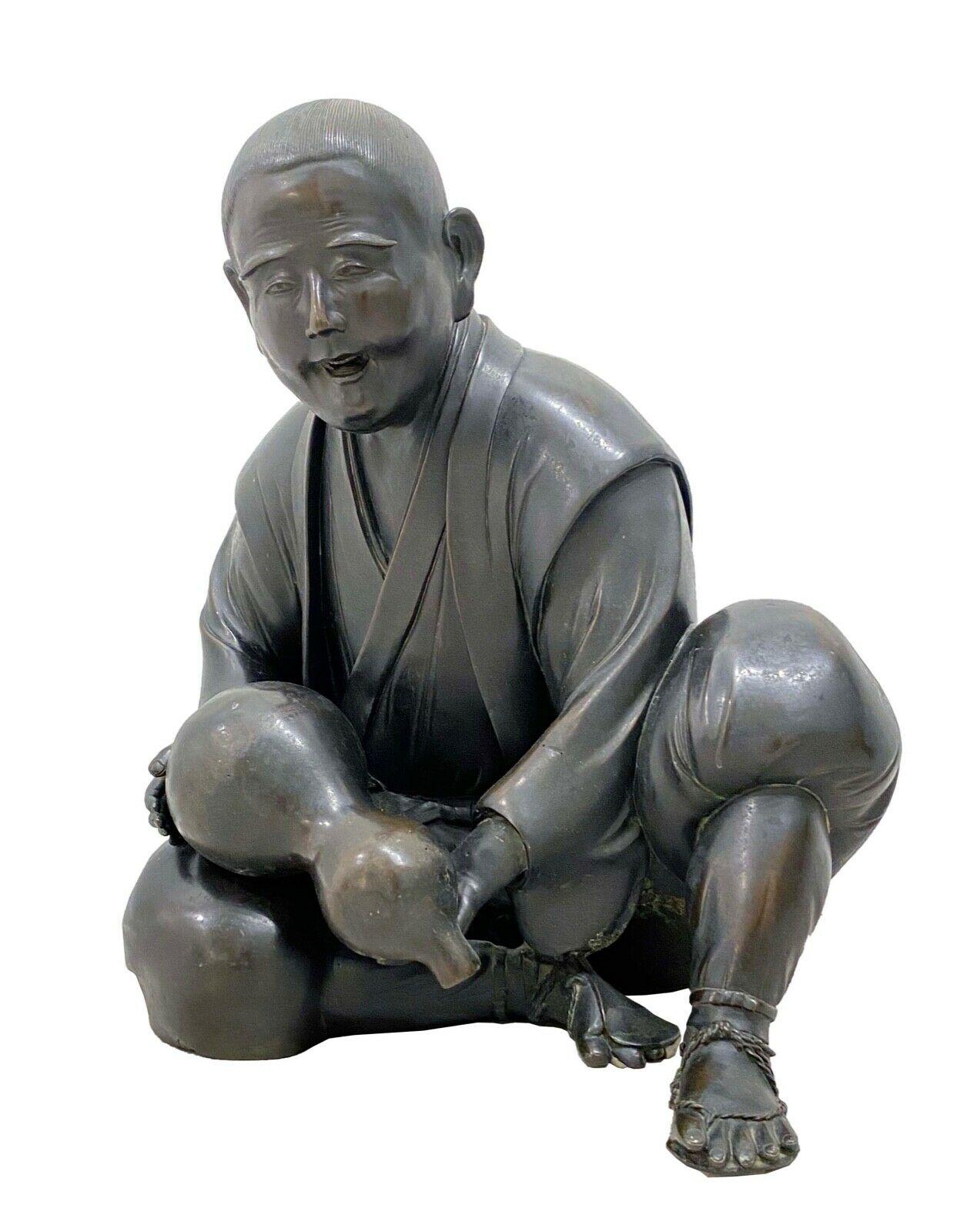 Vintage Chinese figurative scholar holding gourd. Incredible sculptural details. Monumental in size. His one hand is a bit dislodged from the opening. It was cast as a separate piece.
 
Dimensions: 19 W X 15.5 D X 21.5 H.