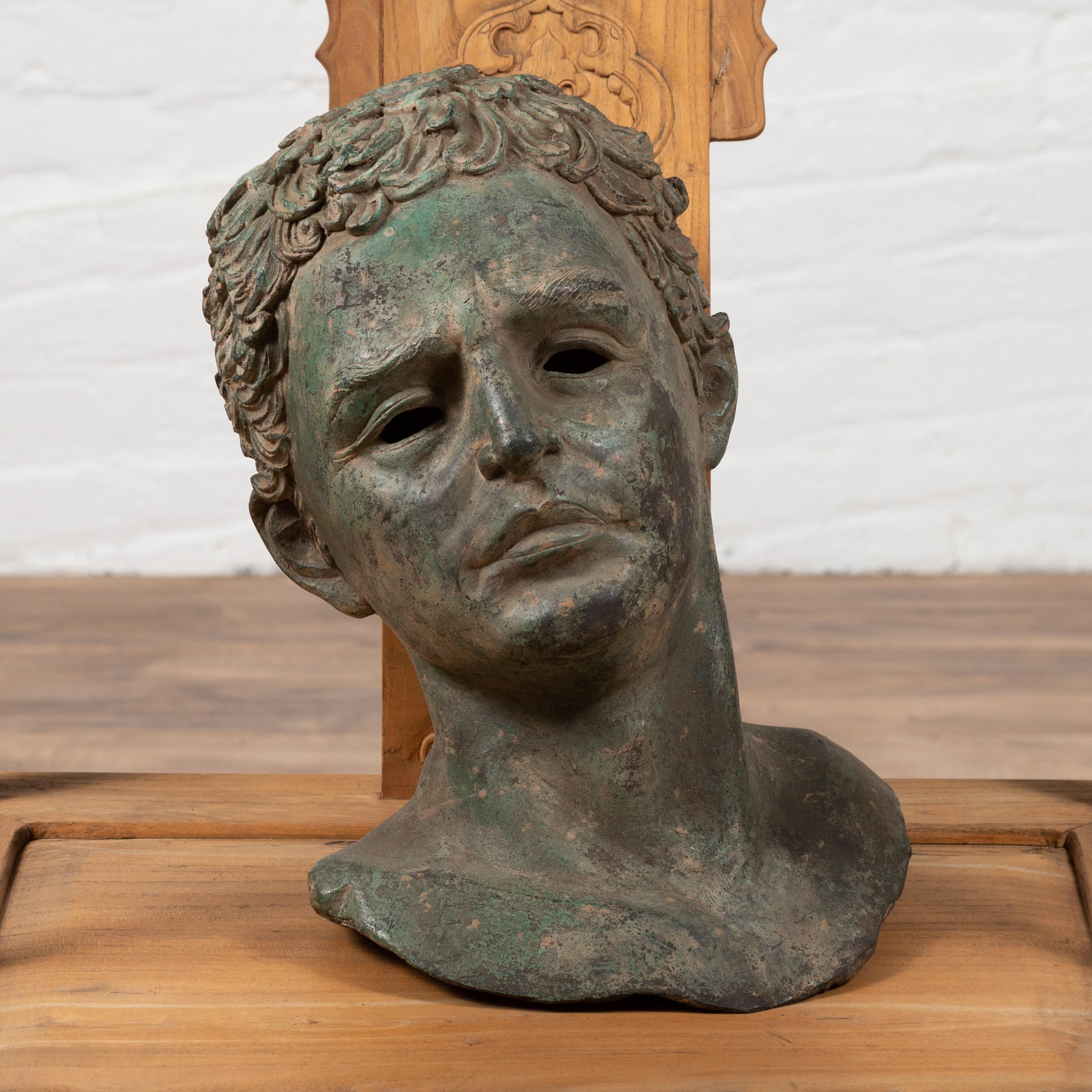 A vintage bronze bust of a Roman philosopher from the mid-20th century, with green oxidized patina and great details. Born during the midcentury period, this exquisite bronze bust depicts a handsome Roman philosopher featuring a stunning verdigris