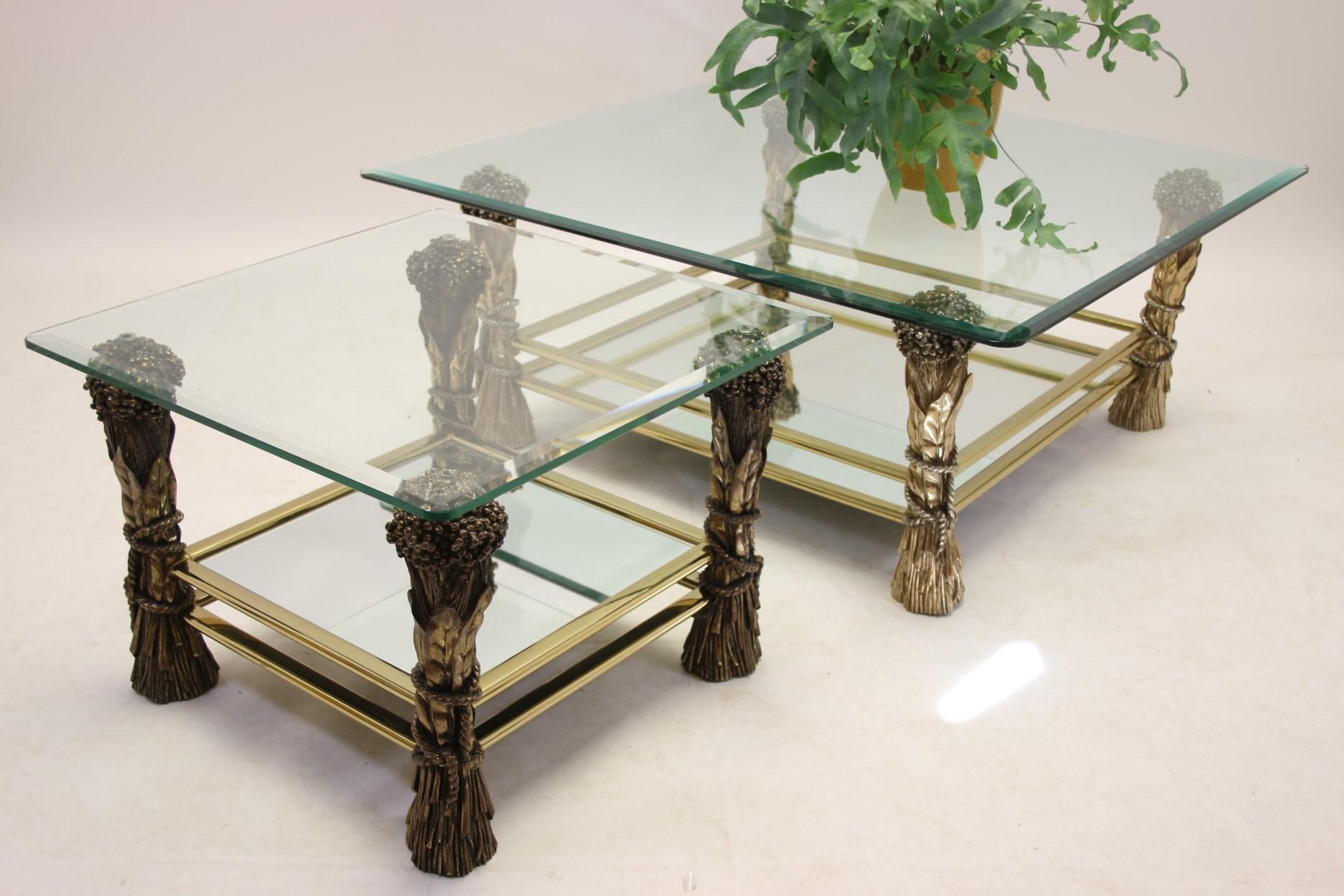 A beautiful set of a coffee table with a matching side table. This set was made in France in the 70s. 

Both tables are made in the classic Hollywood Regency style. This can be recognized by the combination of glass with fine gold-coloured