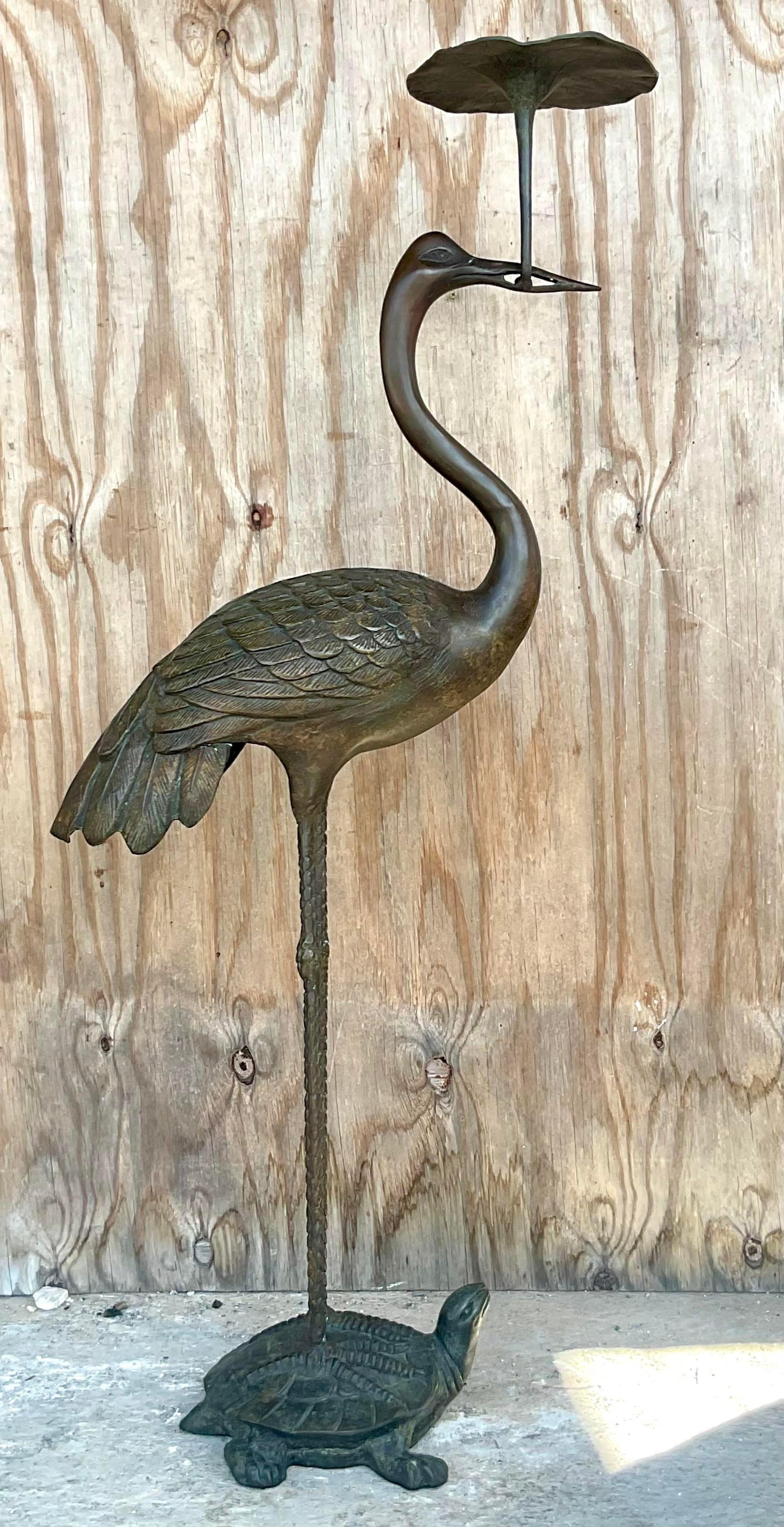 A fantastic vintage Boho bronze floor candle holder. A chic tall crane standing on top of a turtle. A charming little lily pad in his beak serves as the candle holder. Acquired from a Hobe Sound estate