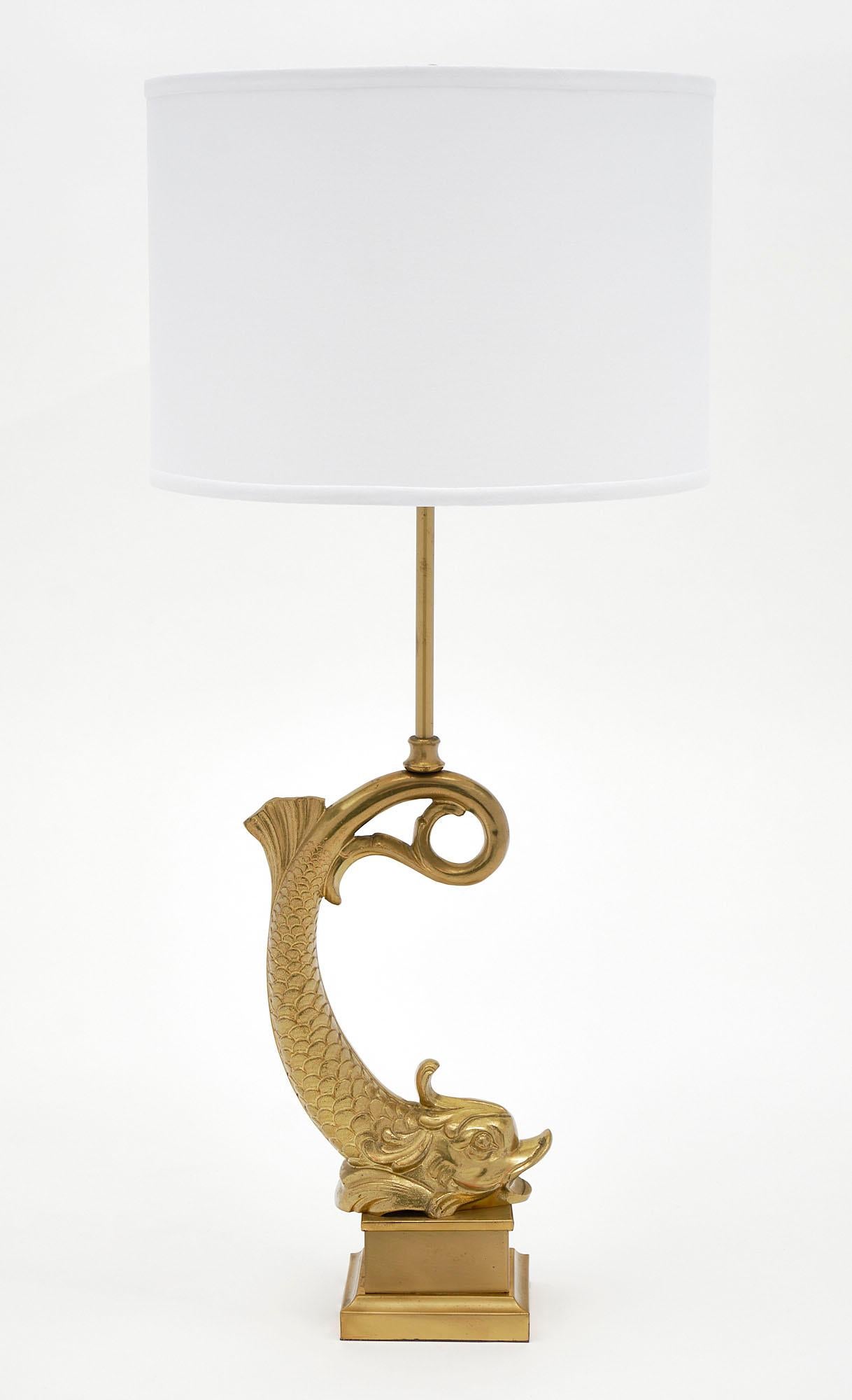 Neoclassical stylized vintage bronze dolphin lamp by Maison Charles. This gilded bronze piece is French and has been newly wired to fit US standards.