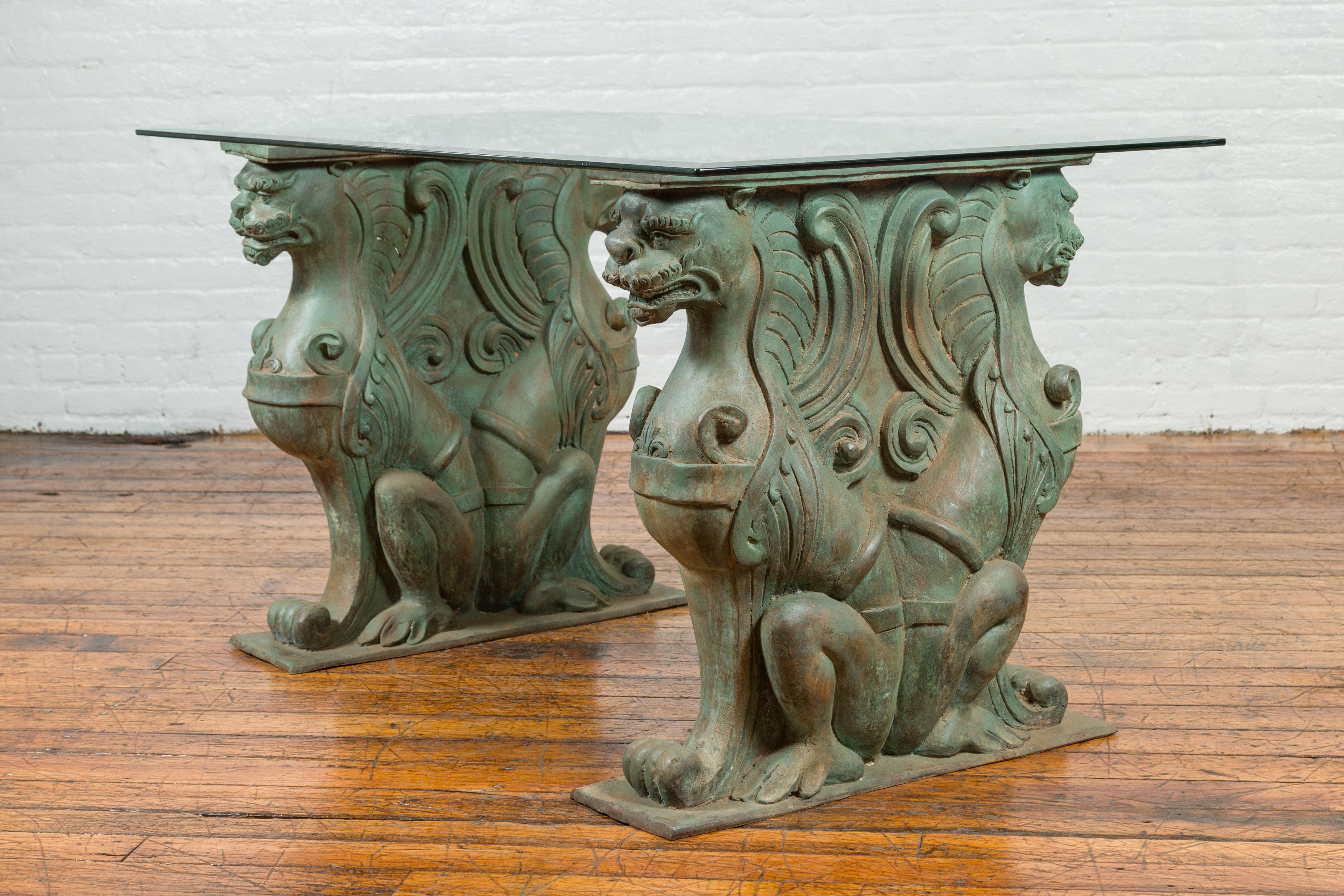 A vintage bronze double mythical figures table base from the mid-20th century, with verde patina. The top is not included but shown on the photos to allow a better visualization of the possibilities. Created with the traditional technique of the