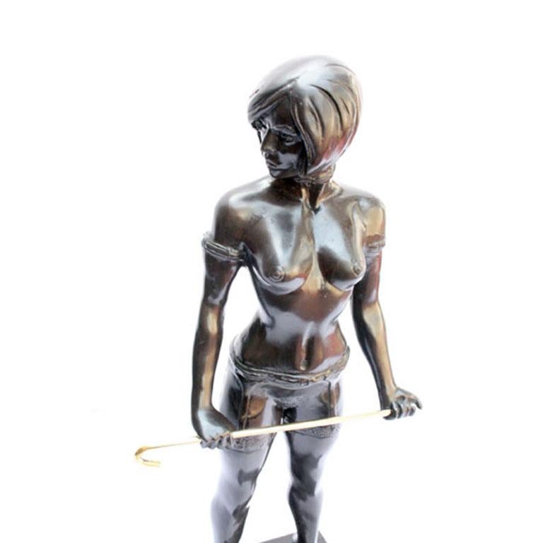 This is a striking bronze Art Deco style dominatrix lady bronze on a marble base, after Bruno Zach, from the last quarter of the 20th century.

This bronze statuette is of a dominatrix carrying a cane, which she clutches with both hands, while