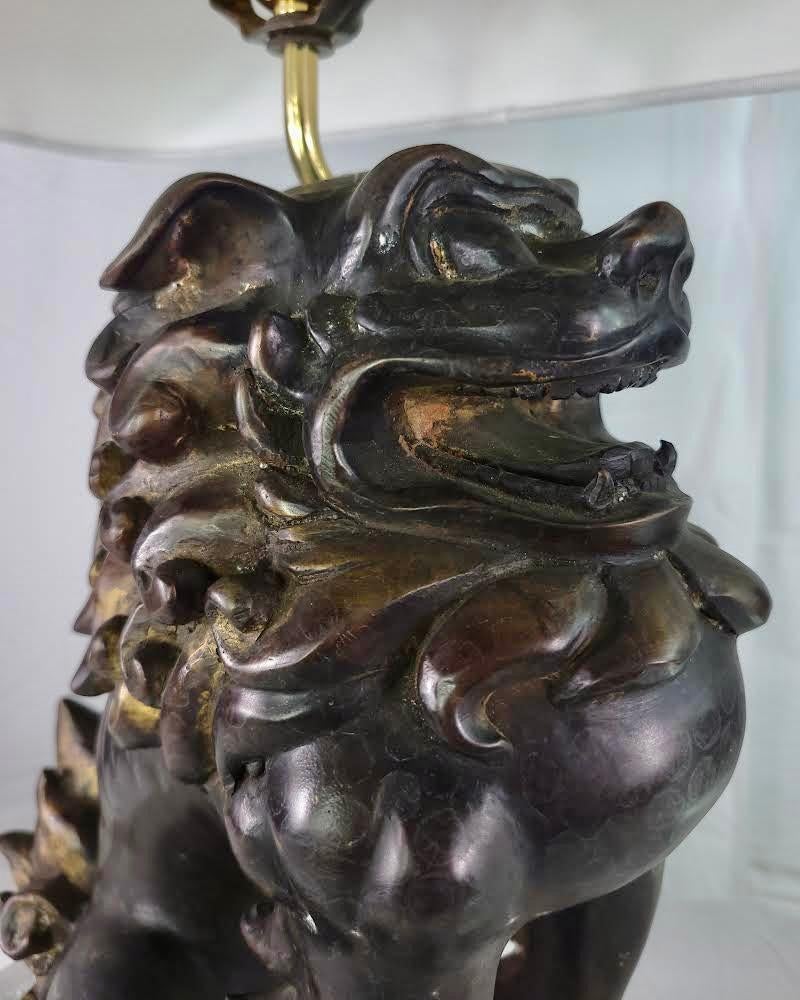 The dramatic bronze Foo Dog Lamps by Remington Lighting exude a majestic presence, blending traditional symbolism with modern design elements. Crafted from bronze, these lamps showcase intricate detailing, capturing the ferocity and mystique of the