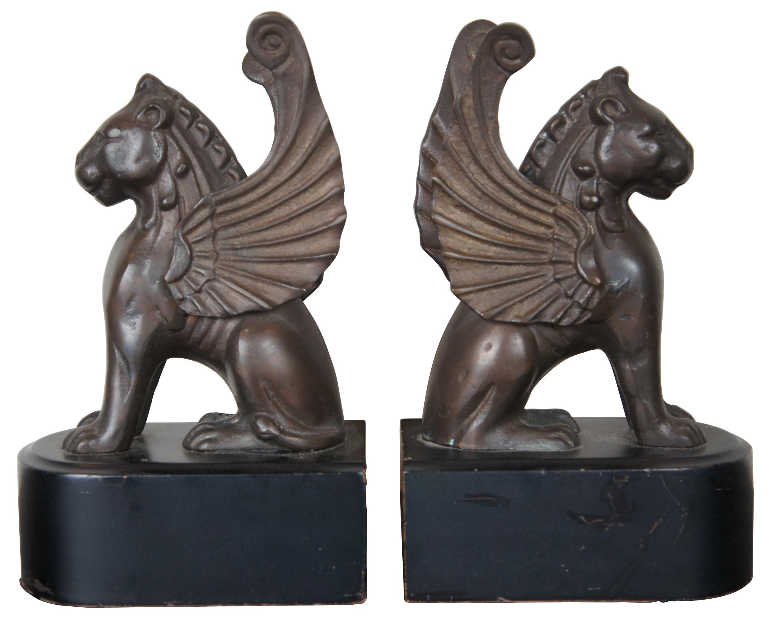 Vintage bronze gryphon or winged lion library bookends on wood bases.