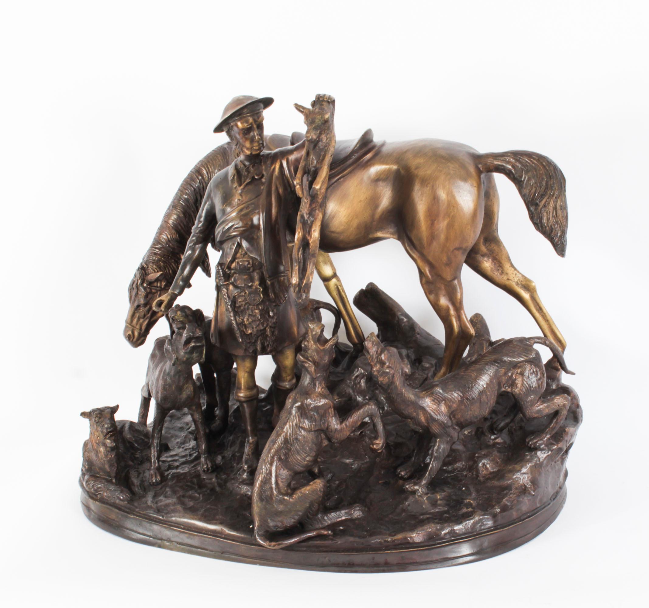 This is a superb vintage patinated bronze group of a hunter holding a fox over his hounds, dating from the late 20th Century.

The bronze comprises a central Scottish hunter dressed in a traditional kilt holding a fox surounded by his hounds, with