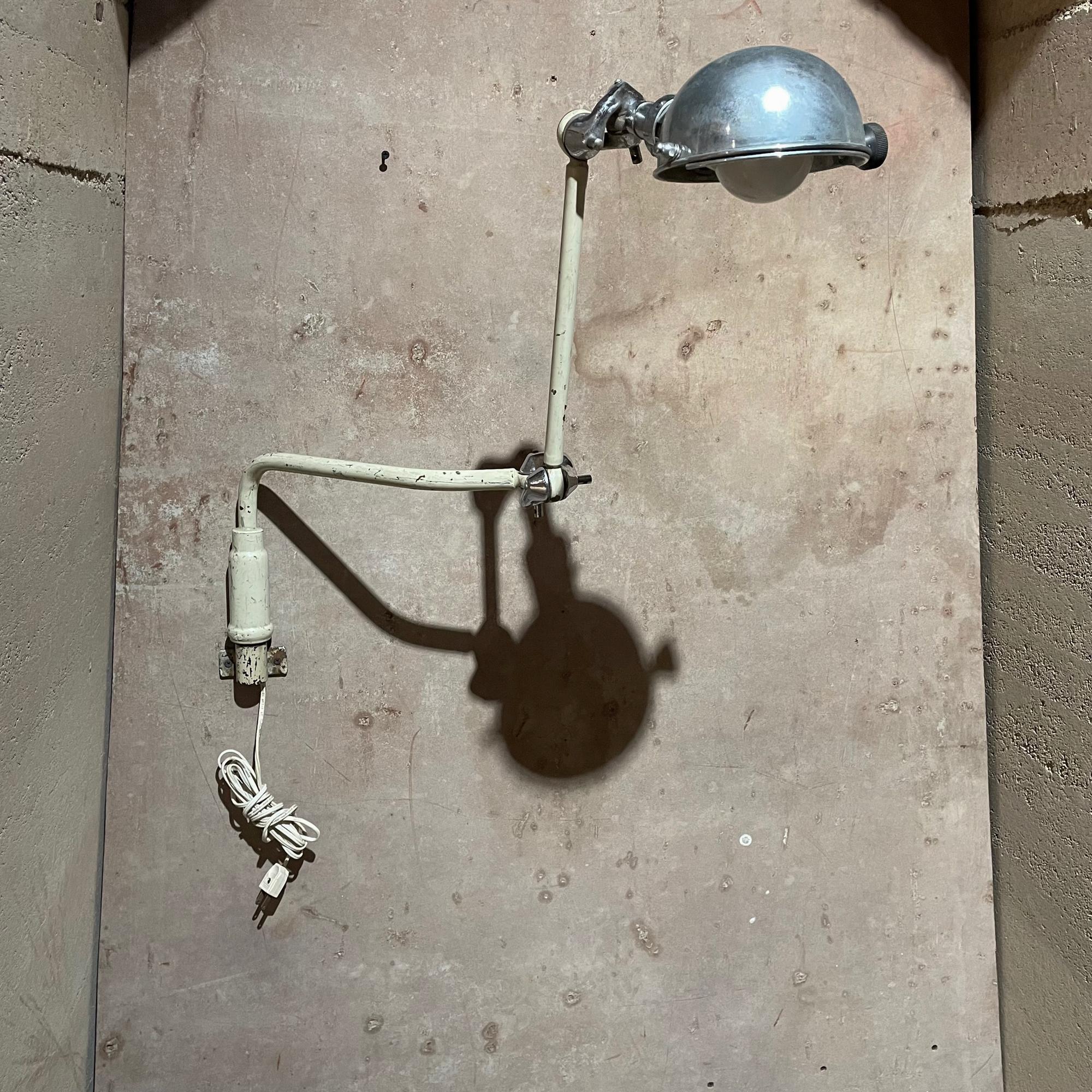 Wall Sconce Lamp
Vintage Industrial medical light surgical dental wall sconce lamp circa 1930s
Constructed in bronze and brass. Brass is chrome-plated.
The bronze body is painted white some areas are chrome-plated. 
Lamp has multiple adjustments for