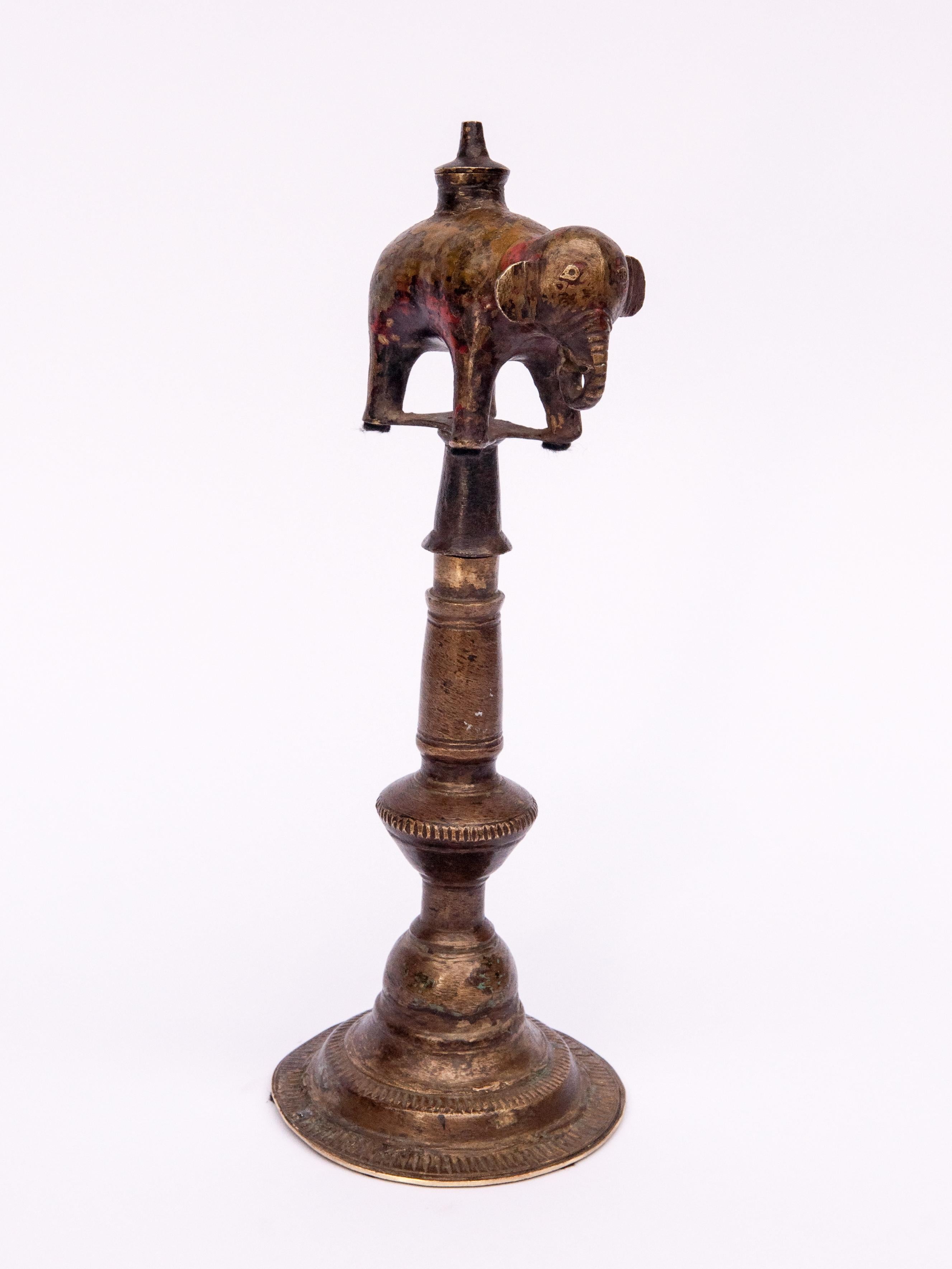 Vintage bronze oil lamp elephant motif. West Nepal, mid-20th century.
This charming elephant lamp comes from the mountains of west Nepal. It was handcrafted in bronze by village craftsmen utilizing basic casting tools and methods, and reflects the
