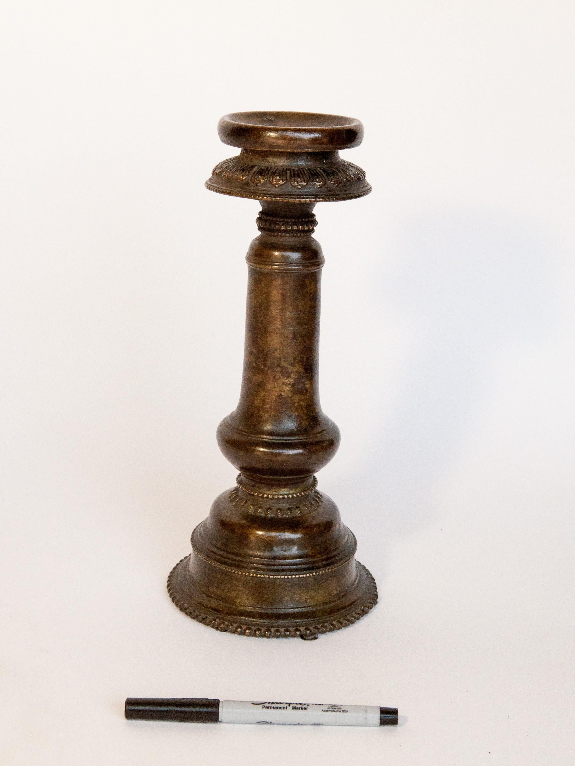 Vintage bronze oil lamp. Newar of Kathmandu Valley, Nepal, Mid-20th century.
The Newar of the Kathmandu Valley are renowned for their metal work. This somewhat rustic lamp has a lotus motif, and a rich natural patina. Such lamps are important