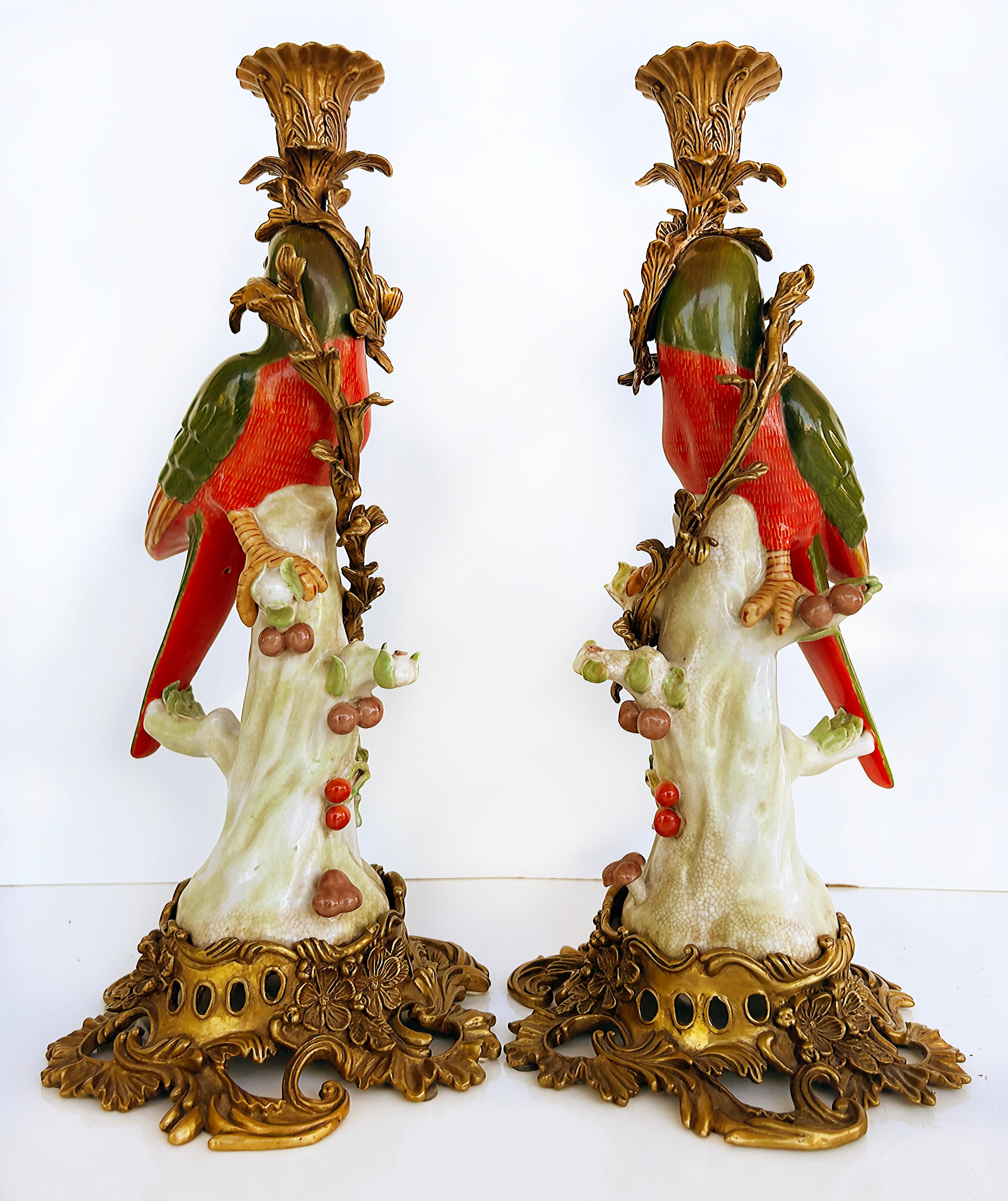 Vintage Bronze Painted Porcelain Exotic Bird Candlesticks, Pair

Offered for sale is a pair of hand painted porcelain bird candlesticks with craquelure glazes and painted gilt details which are presented on ornate bronze bases. The pair of