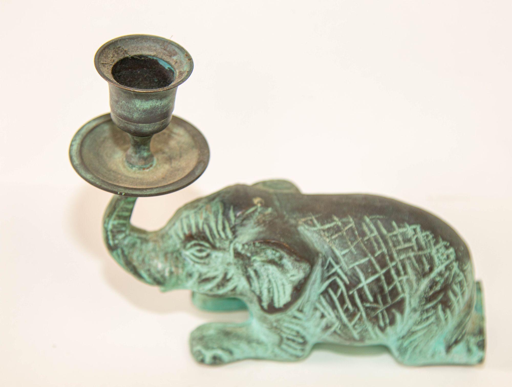 Vintage bronze elephant candle hders with trunk up, good fortune heavy metal with green patina.Vintage Bronze Patinated Green Metal Elephant Candle Hder Fortune Trunk Up .The elephant candlestick hder with lucky raised trunk.Rajasthani elephant