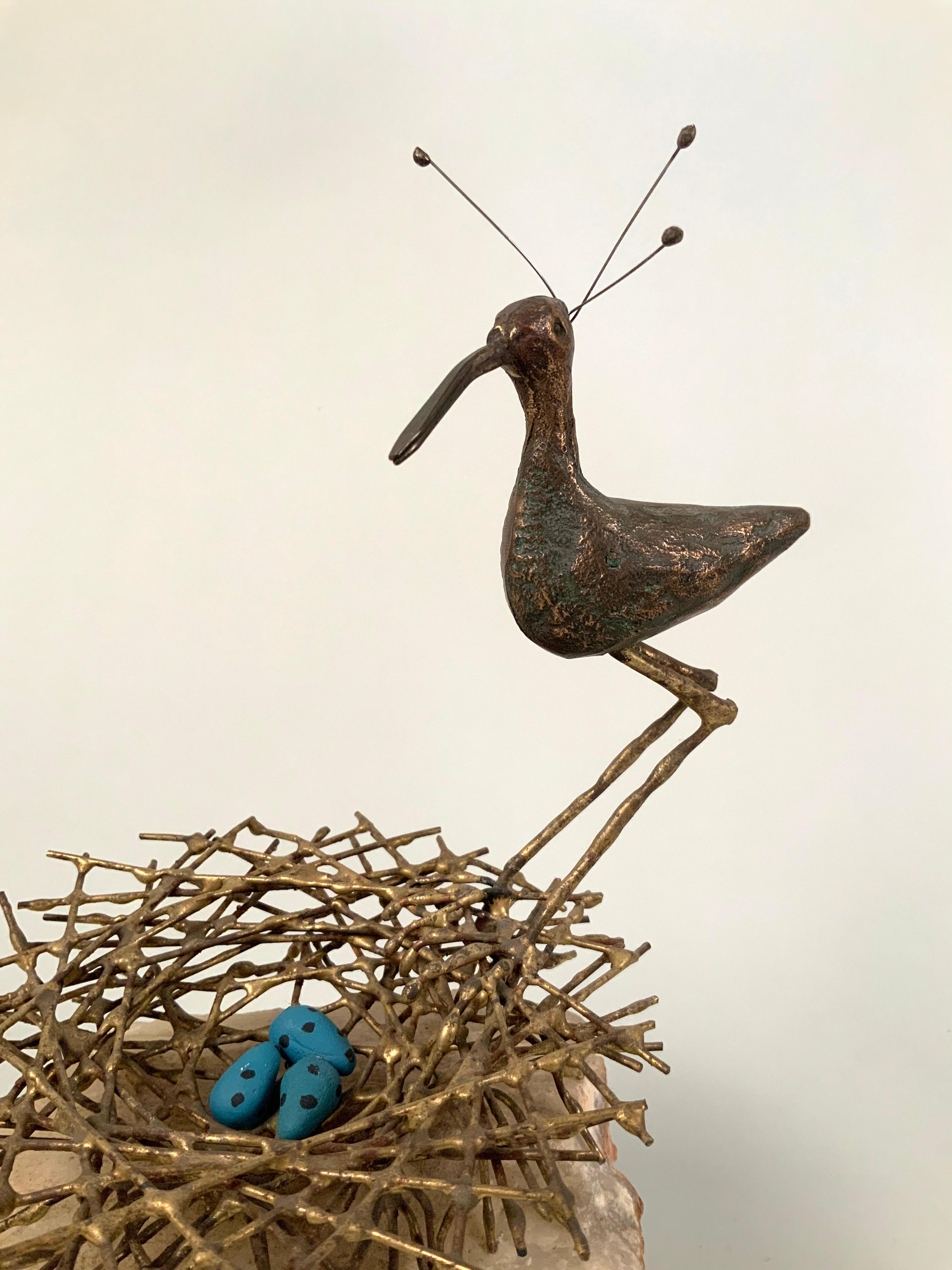 A beautiful vintage sculpture by Curtis Jere, featuring a bronze plover bird, perched on the edge of a brass next with three small bright blue eggs, all mounted on a rough natural marble block. Exceedingly charming and very sweet. Signed.