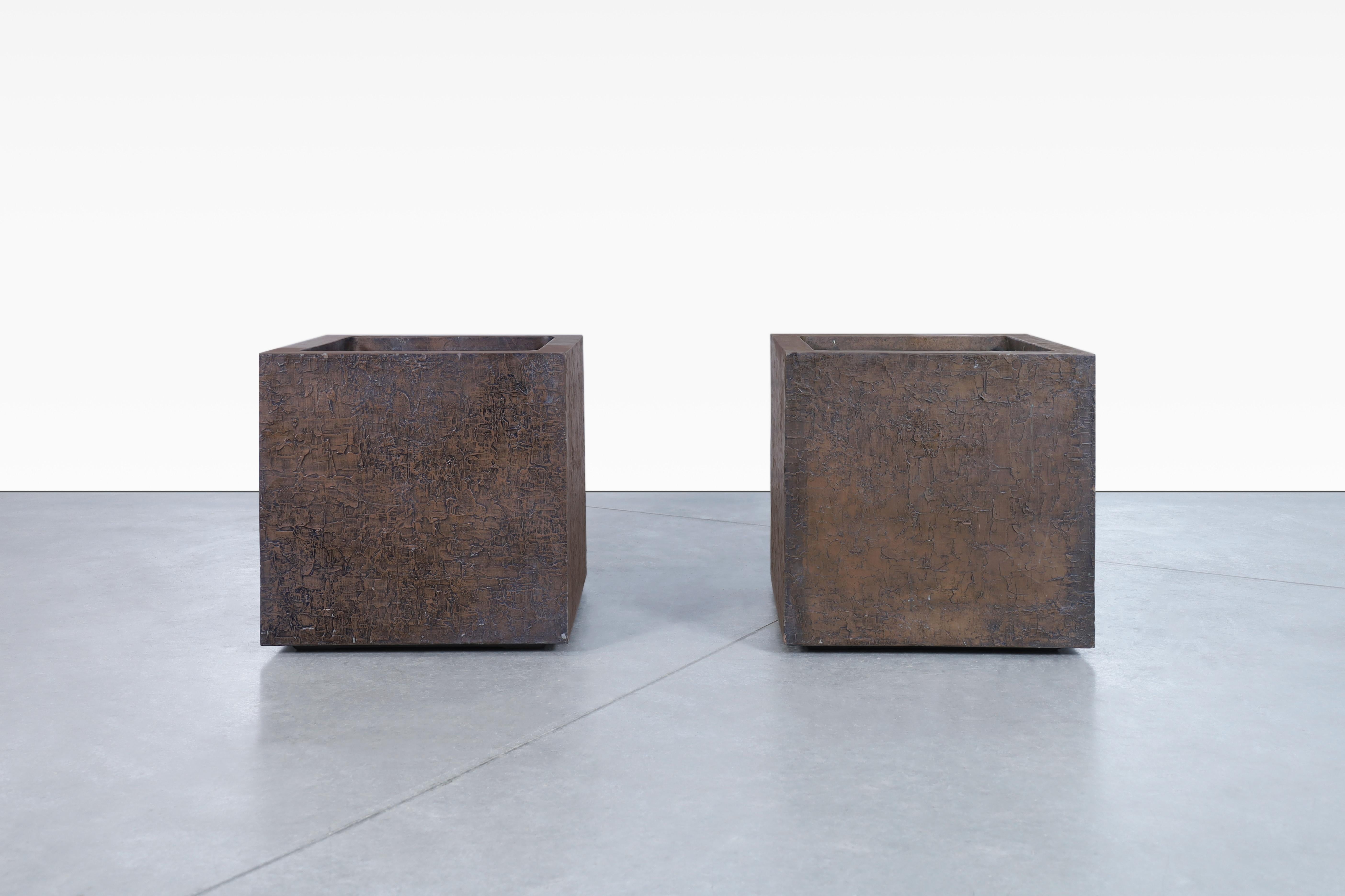 Beautiful mid-century modern bronze resin square planters manufactured in the United States, circa 1970s. These planters are manufactured by the well-known company Forms and Surfaces, and showcase a harmonious fusion of bronze resin, fiberglass, and