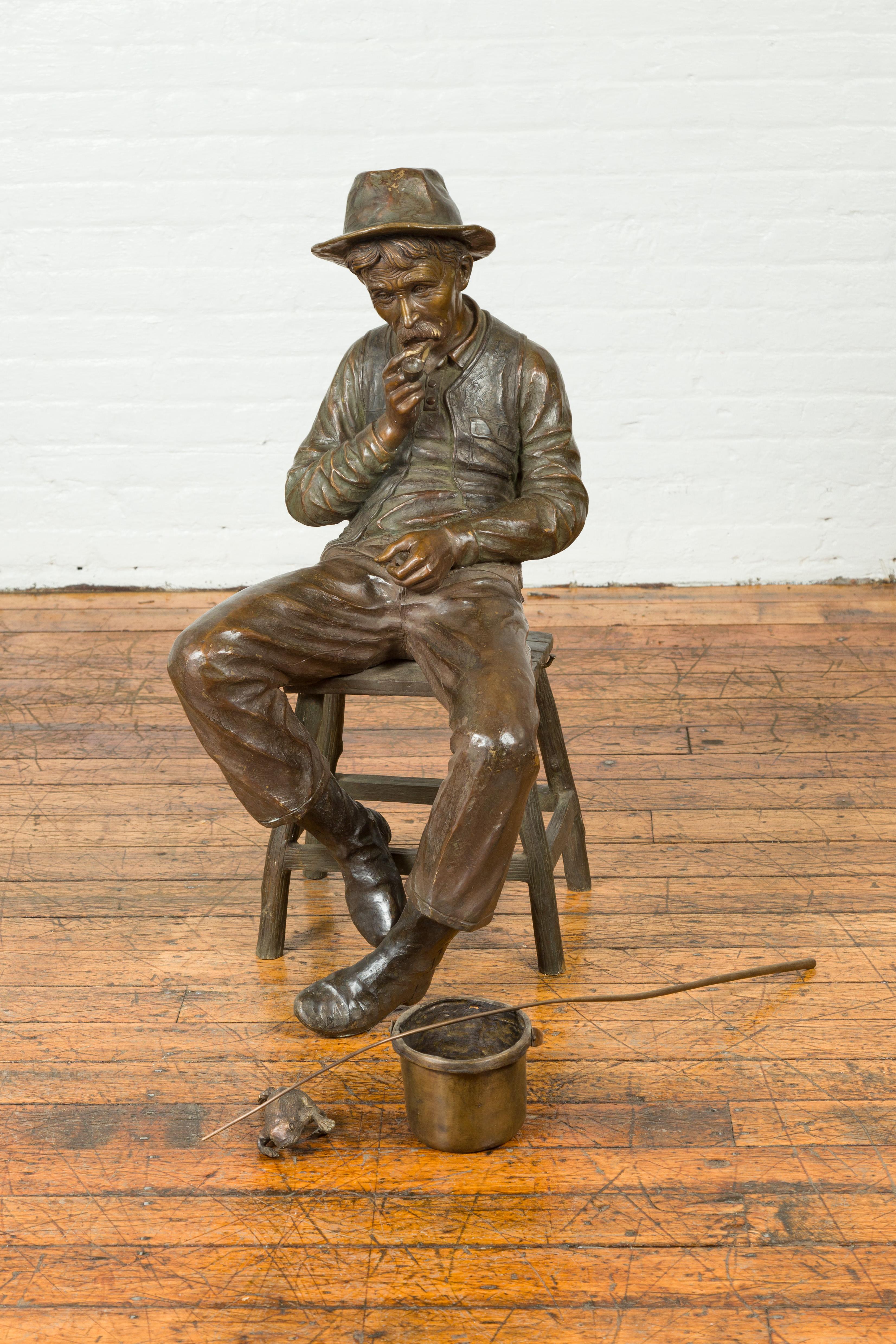 Cast Vintage Bronze Sculpture of a Sitting Old Timer Smoking His Pipe and Fishing