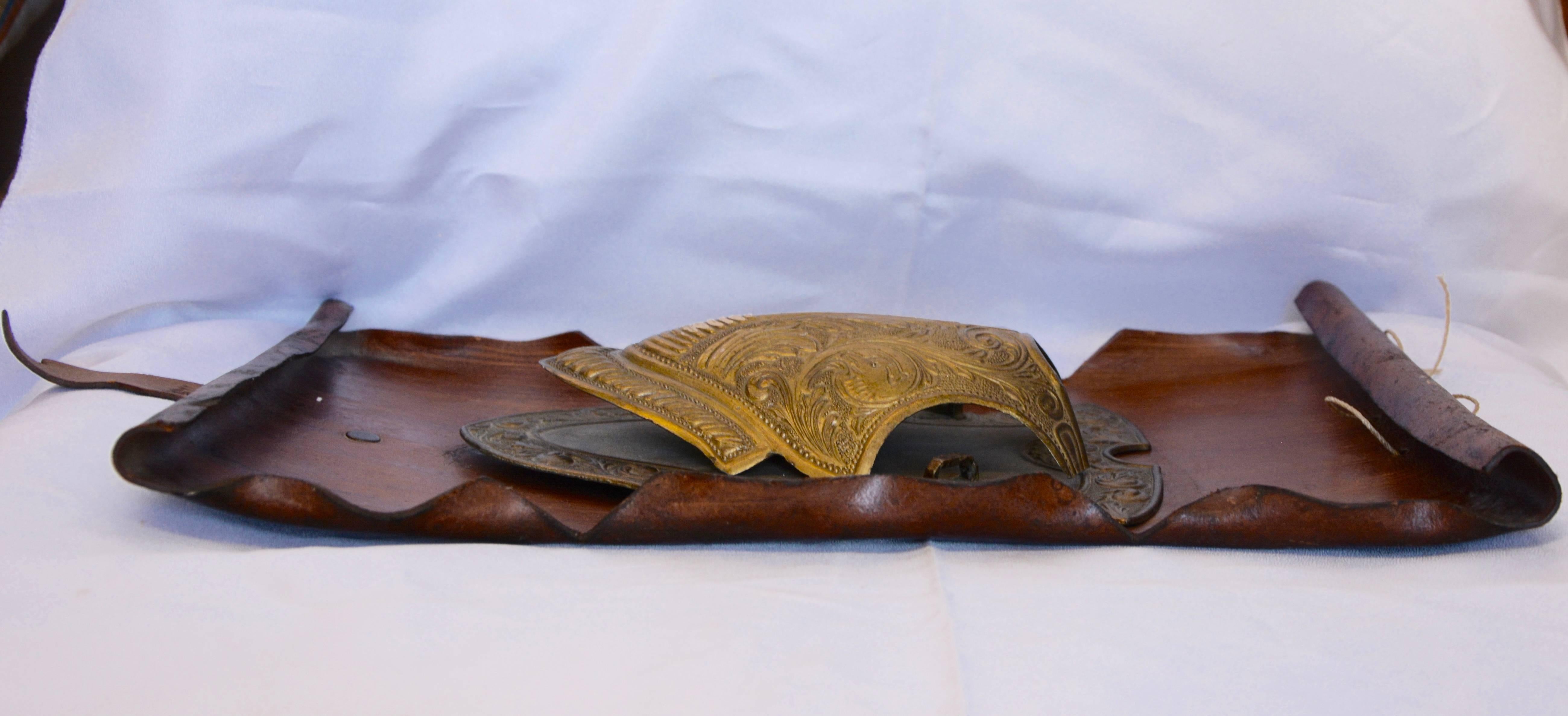 Cast Bronze Shield on Rustic Leather Scroll Wall Hanging For Sale