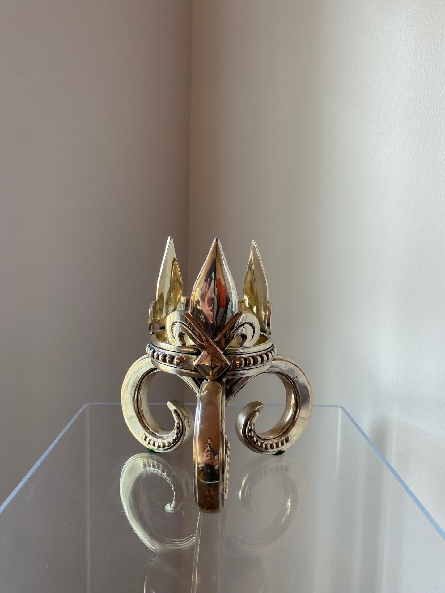 Beautiful vintage bronze candle holder.  This substantial piece has a trio fleur de lis design that surrounds the candle holding base.  The base is elevated with 3 curvaceous legs that add beauty and elevate the piece to sculptural levels.  Unique