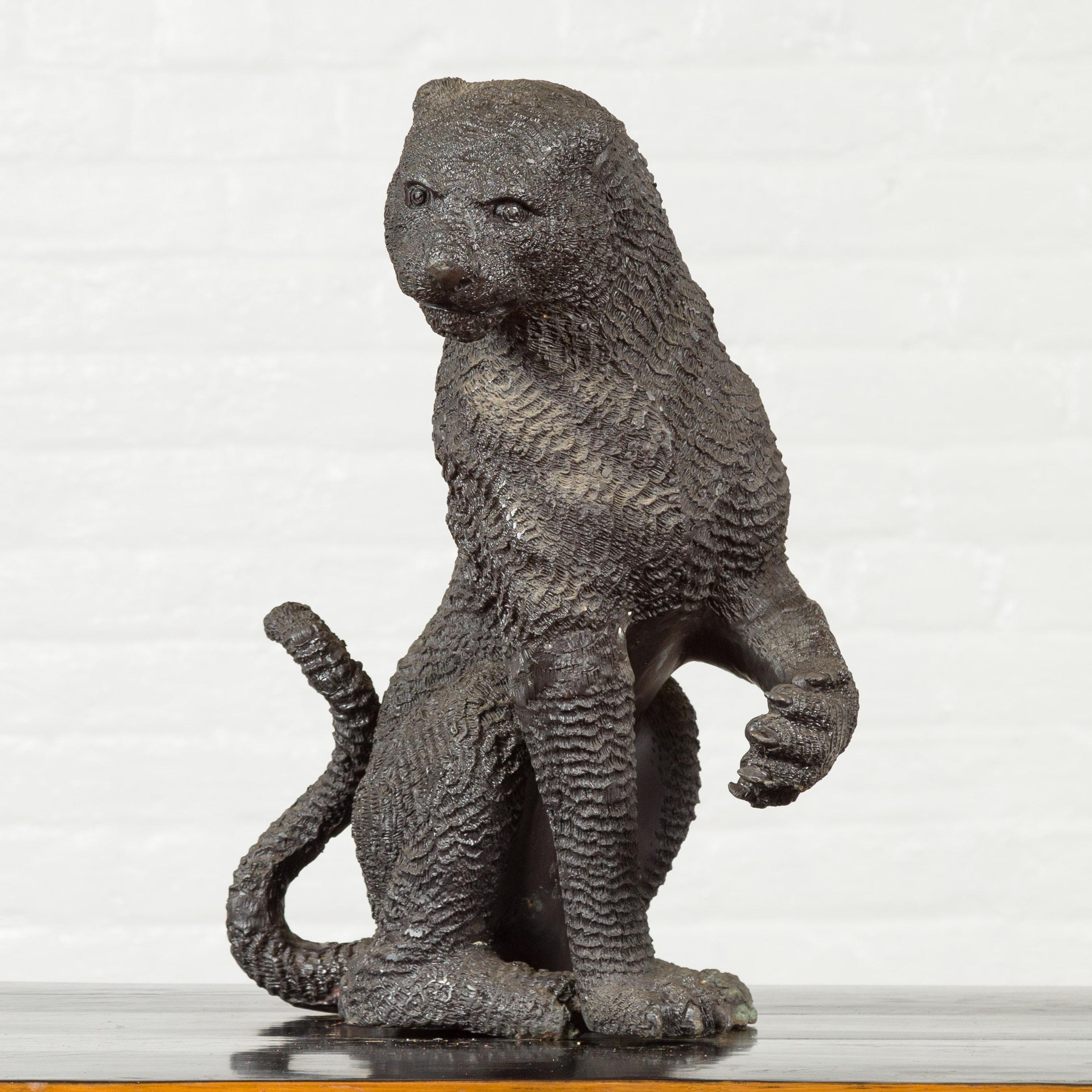 A vintage bronze animal sculpture from the mid-20th century, depicting a sitting panther with textured finish. Created with the traditional technique of the lost-wax (à la cire perdue) that allows a great precision and finesse in the details, this